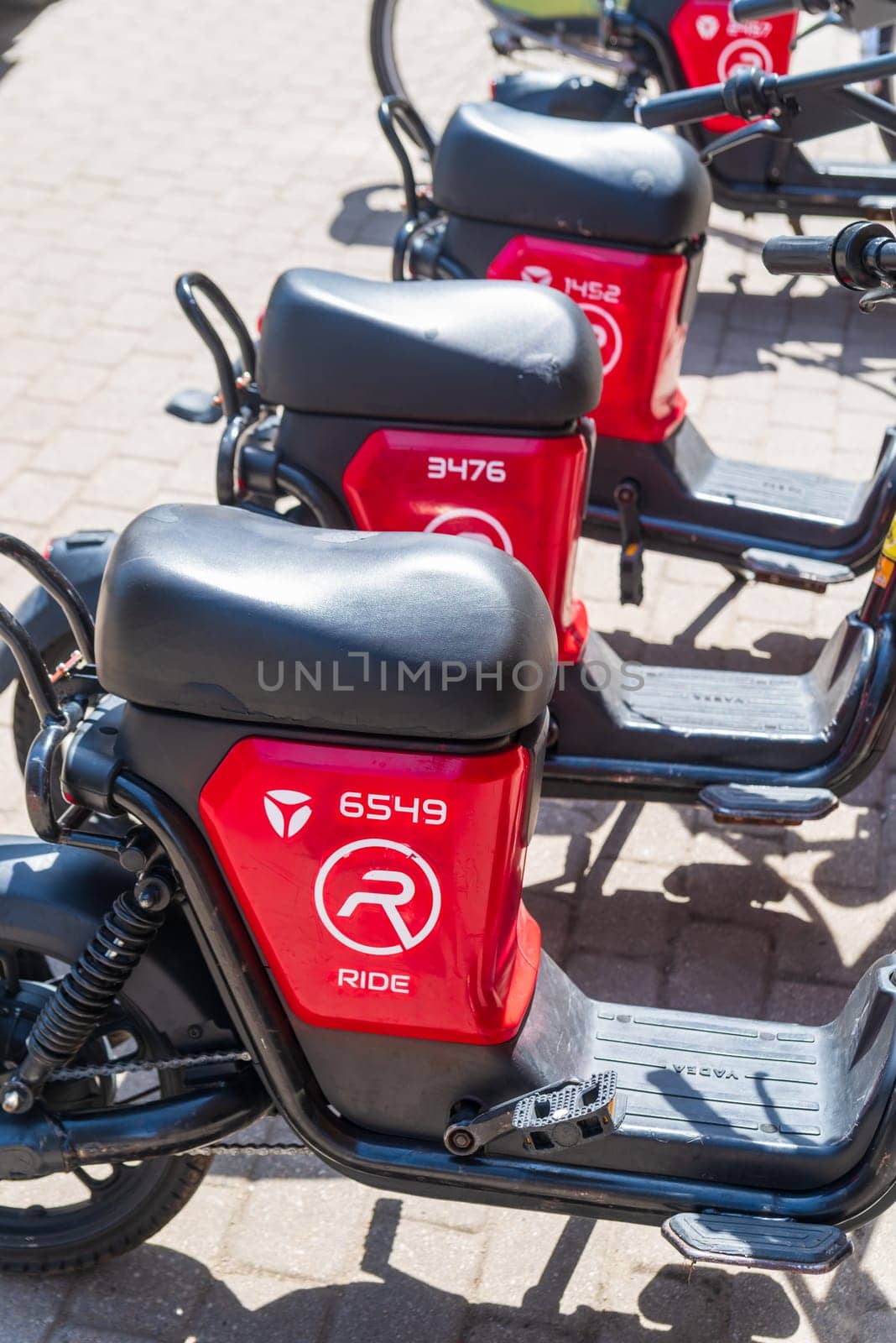 RIGA, LATVIA - JUNE 16, 2024: Electric bikes and scooters for rent in the Latvian capital