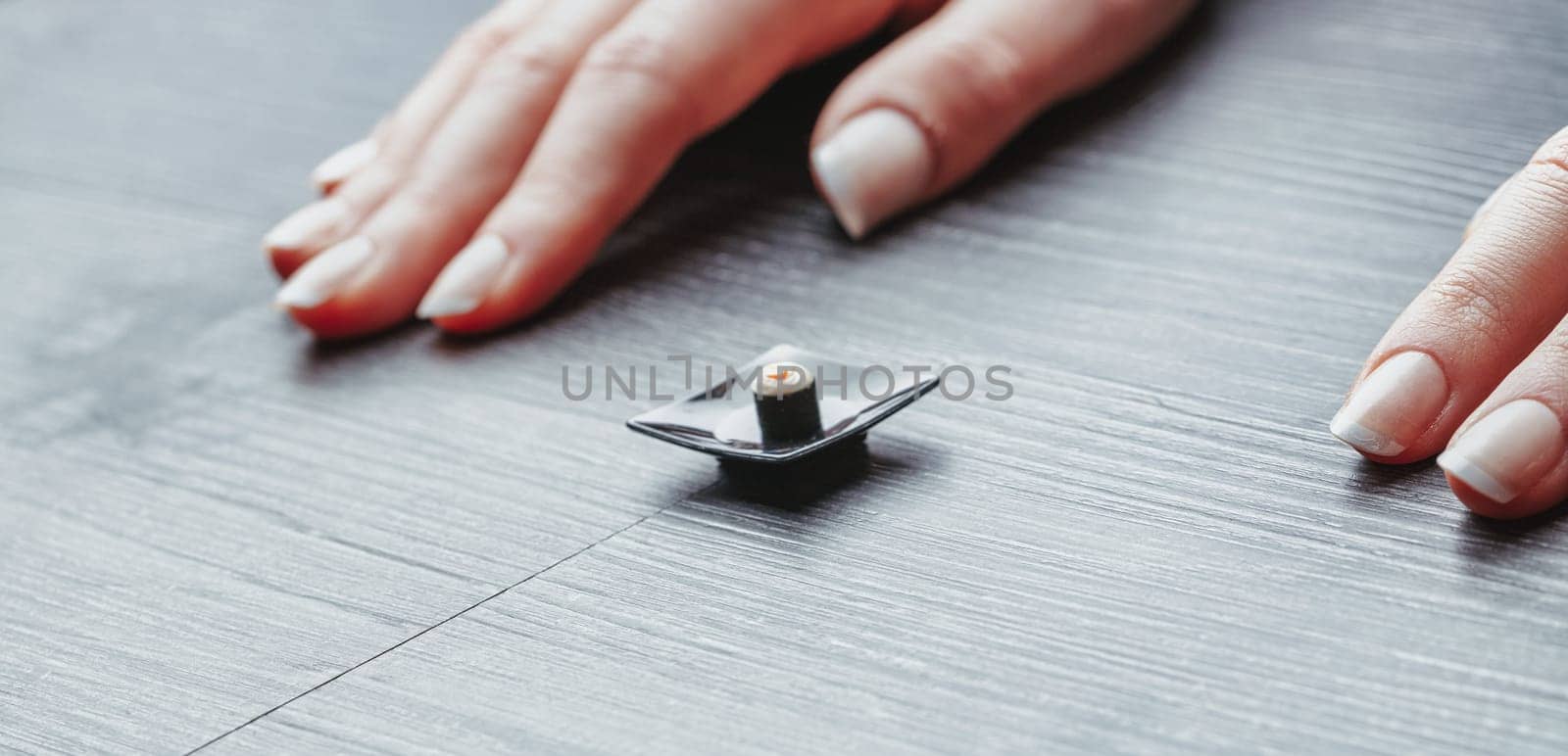 Small sushi portion on a tiny plate illustrates correct dietary habits. While visually minimal, it captures the discipline needed to adapt to correct nutritional portions