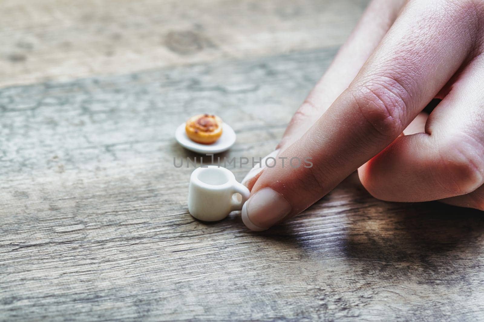 microscopically small coffee and pastry reflect limitations in breakfast due to diet, sugar control, lactose and gluten intolerance, cost, and time. This evokes feelings of unfulfilled morning rituals