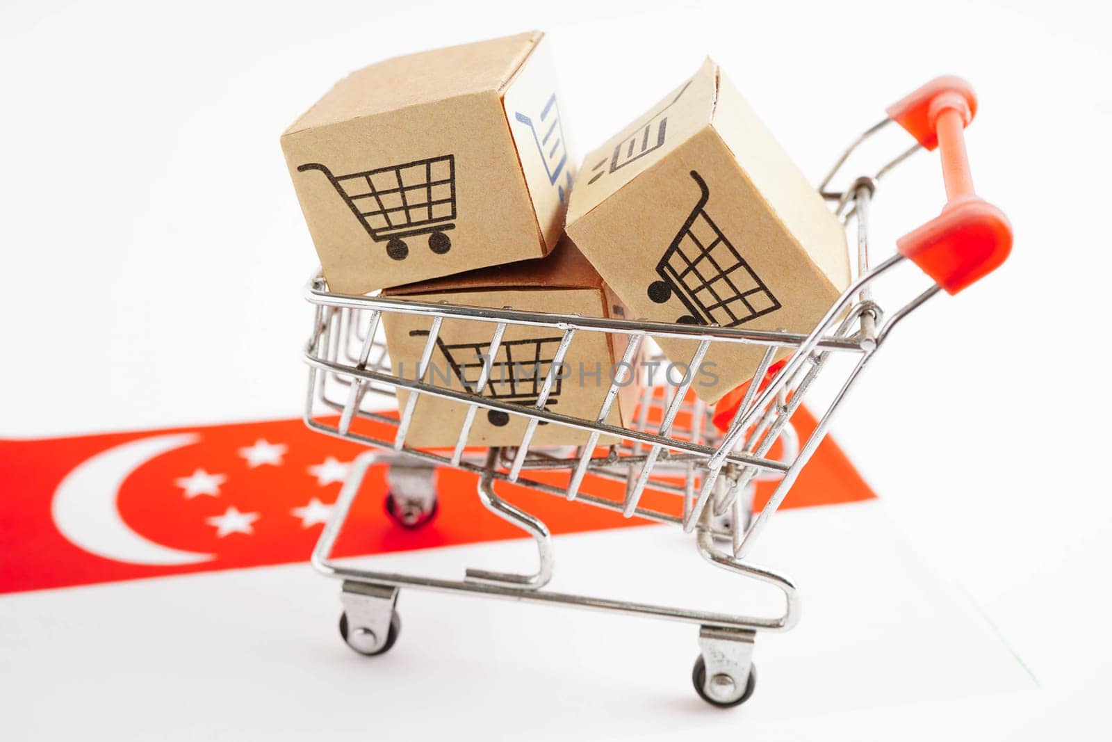 Online shopping, Shopping cart box on Singapore flag, import export, finance commerce.