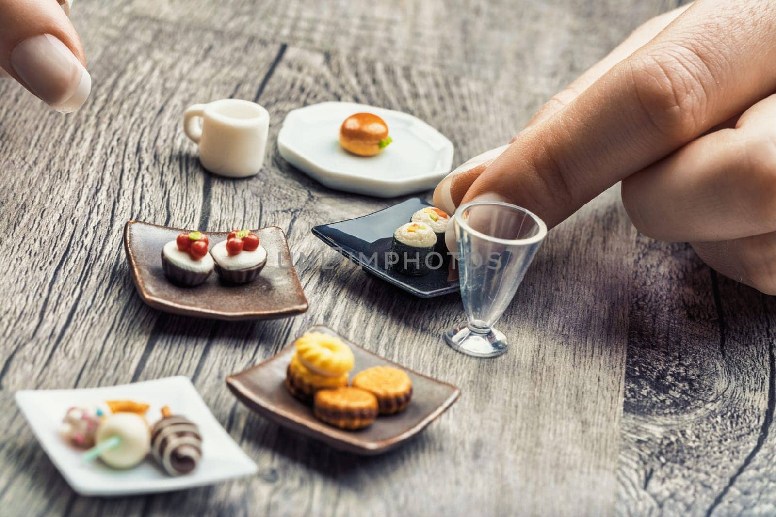 Miniature foods like sandwiches, desserts, and cappuccinos show the discipline required for correct portions. These delicacies, though visually appealing, seem small and unsatisfying