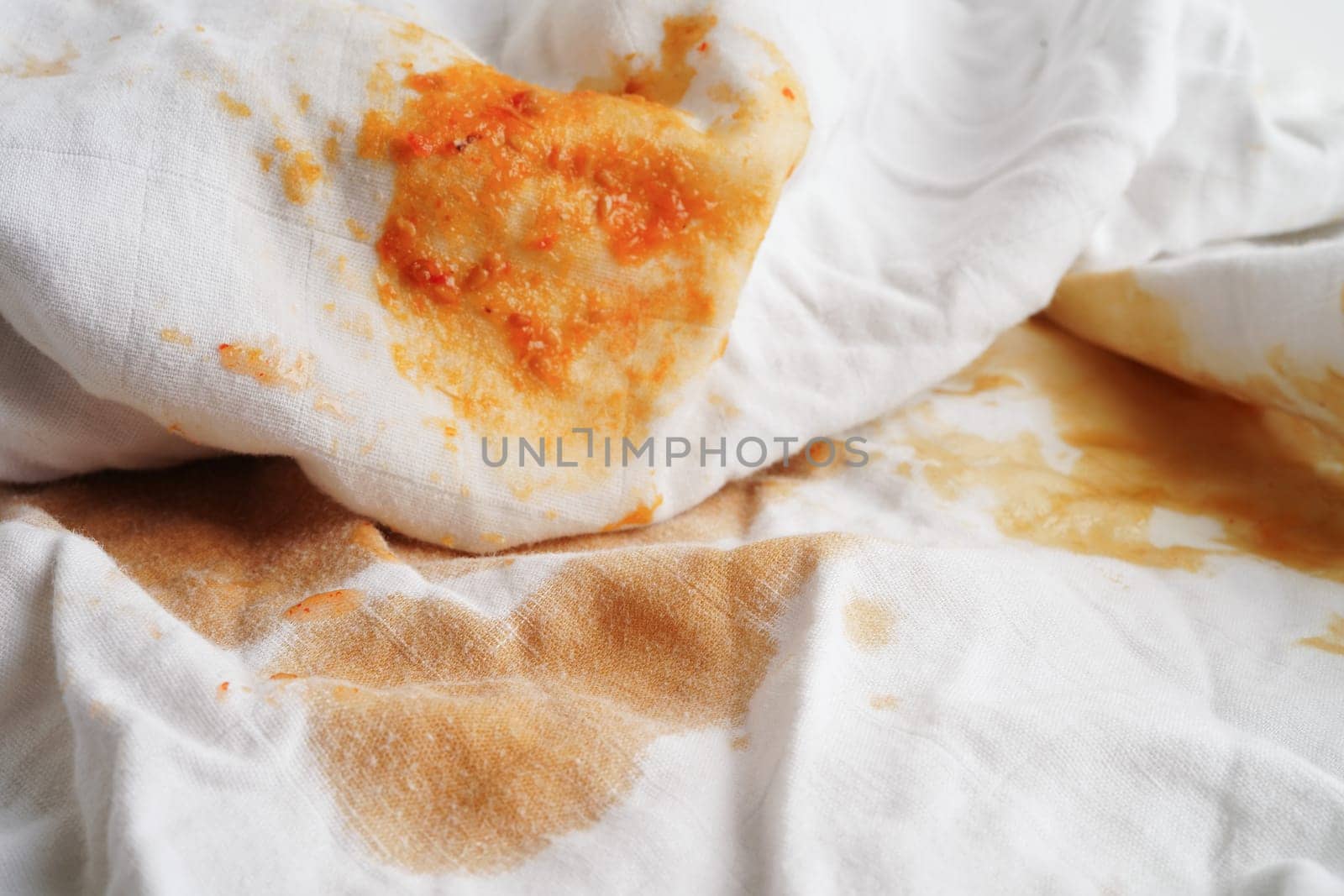 Dirty tomato sauce stain or ketchup on cloth to wash with washing powder, cleaning housework concept.