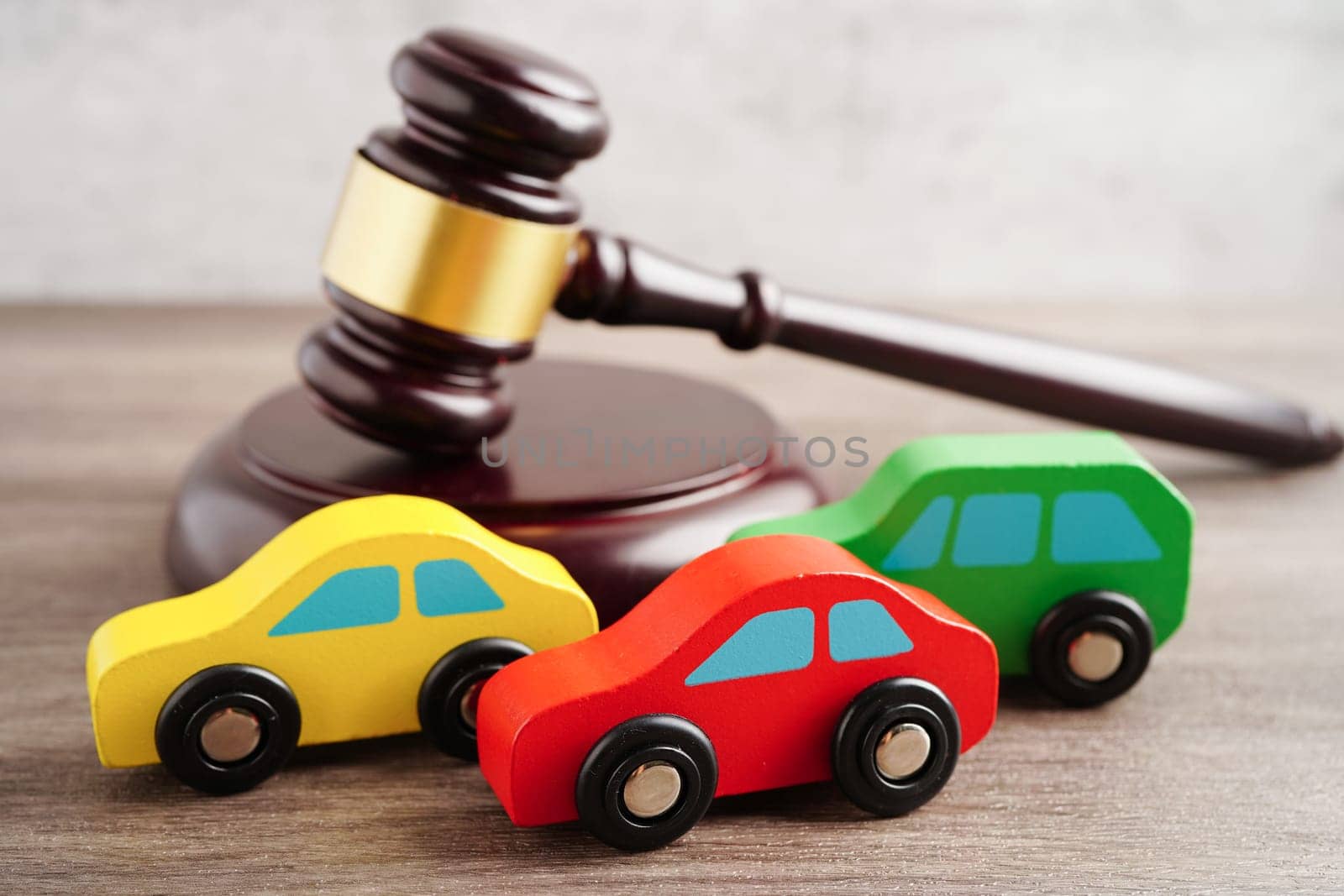 Car accident lawsuit and insurance, Judge hammer with car model.
