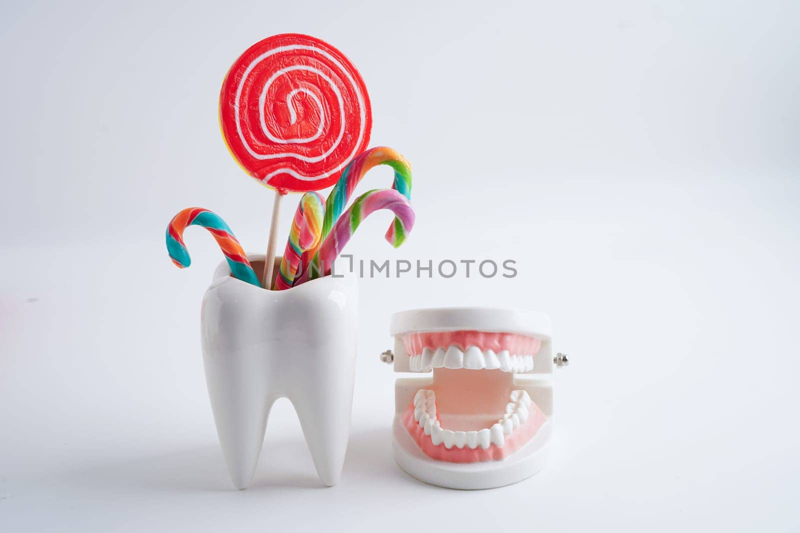 Tooth decay with sweet sugar candy, bad food for dental health care.