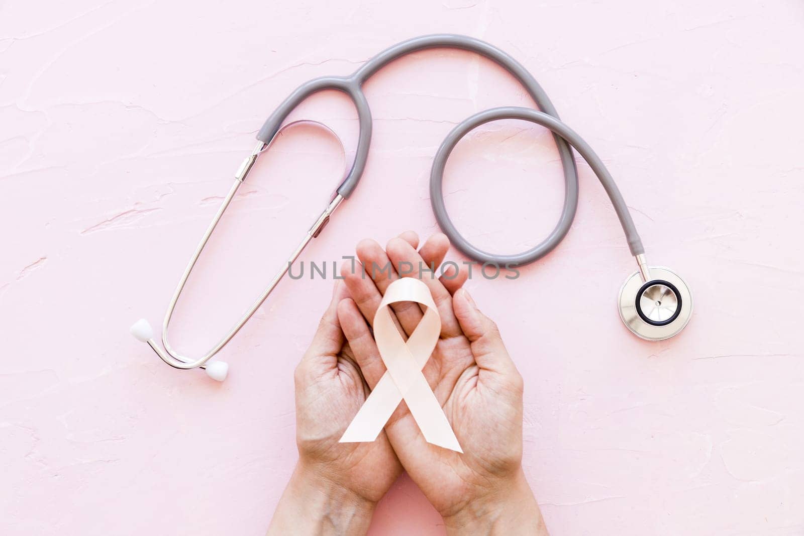 white awareness ribbon two hands with stethoscope pink background 1. Resolution and high quality beautiful photo