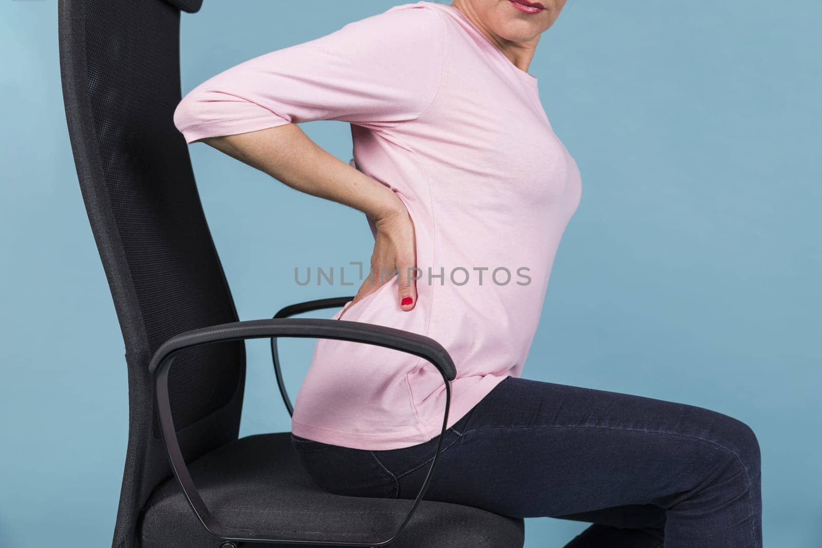 woman sitting chair having backache blue backdrop. Resolution and high quality beautiful photo