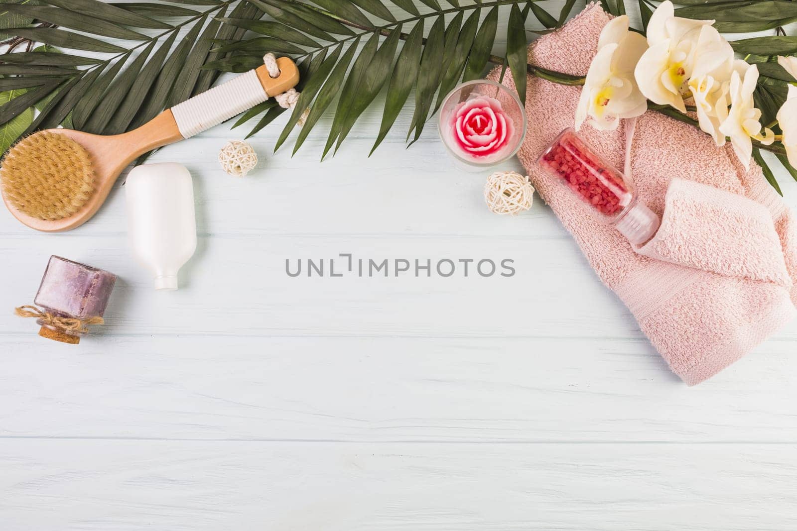 towel salt bottle brush flowers leaves wooden background. Resolution and high quality beautiful photo