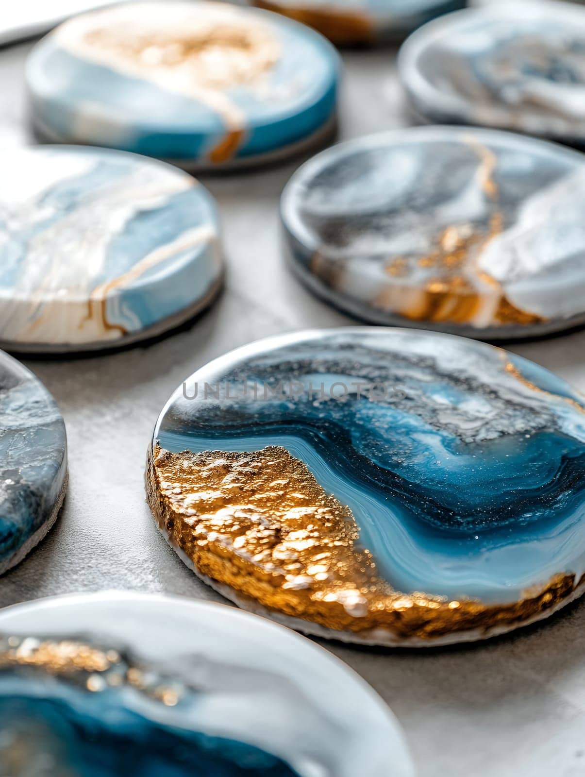 Beautifully crafted resin coasters with blue and gold accents, showcasing artistic design.