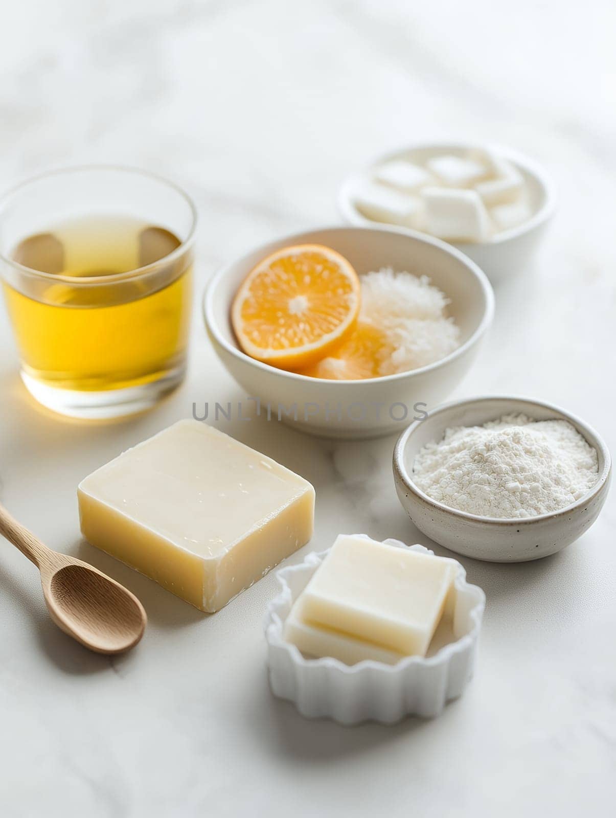 A collection of natural ingredients including soap, citrus, and oil on a light background, ideal for DIY skincare.