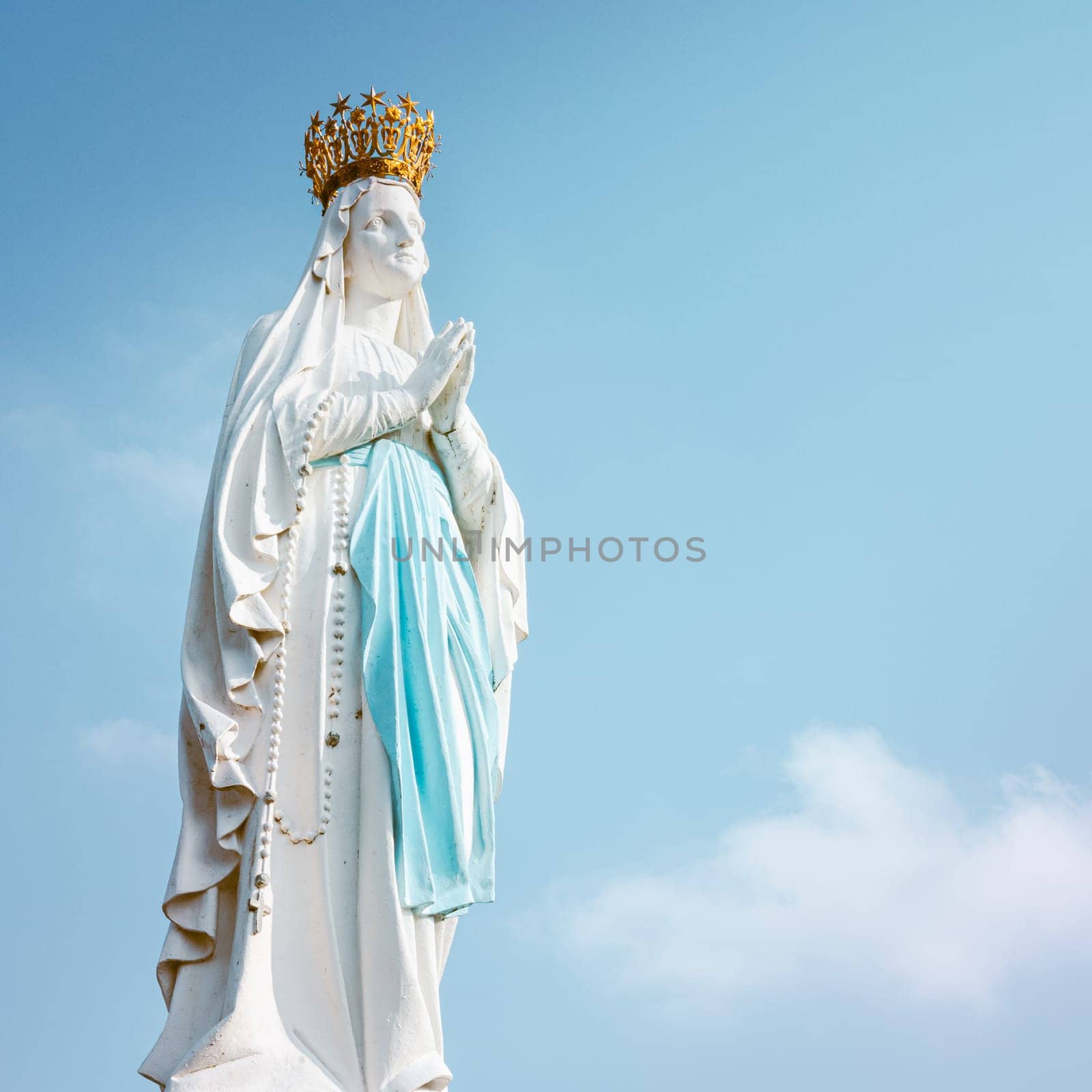 Lourdes, France - August 28, 2021: Sculpture of the crowned Virgin Mary in the Sanctuary of Lourdes in France, square photography