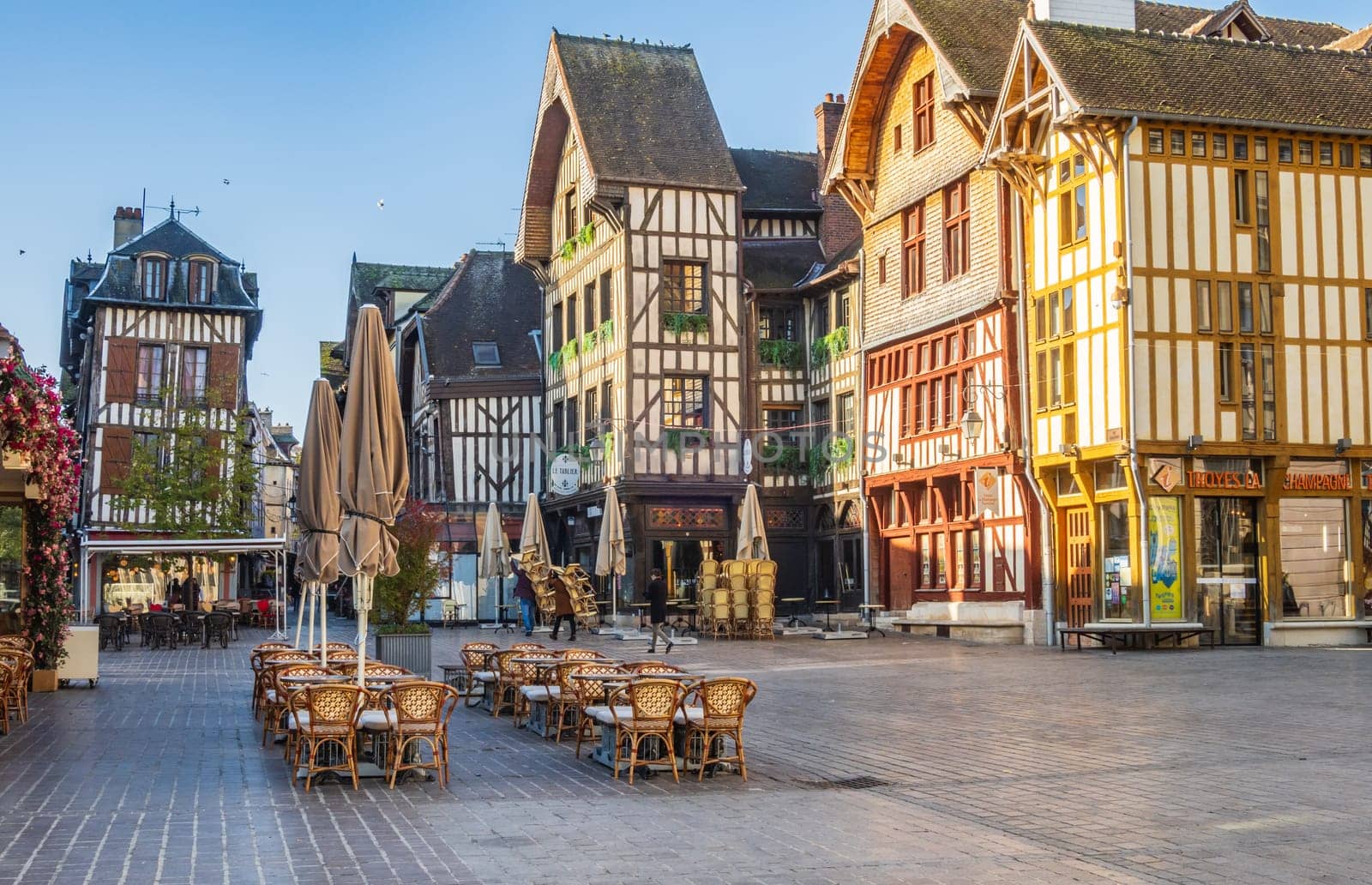 Troyes, France - November 04 2024: Terraces of restaurants and Half-timbered houses at the square place Alexandre Israel in Troyes city