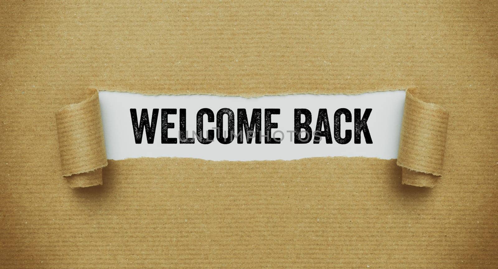 Torn paper revealing the words Welcome back