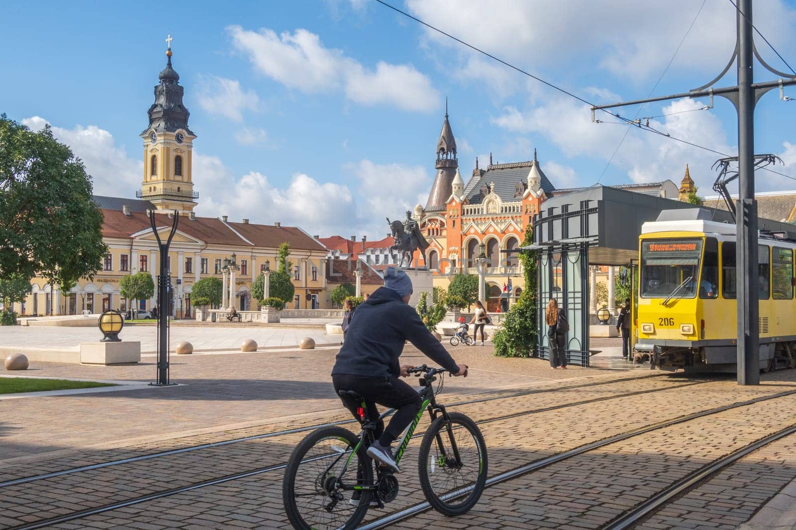 Oradea, Romania - October 07, 2024: Tram and bike on Unity Square in the old town of Oradea, Western Transylvania, Romania