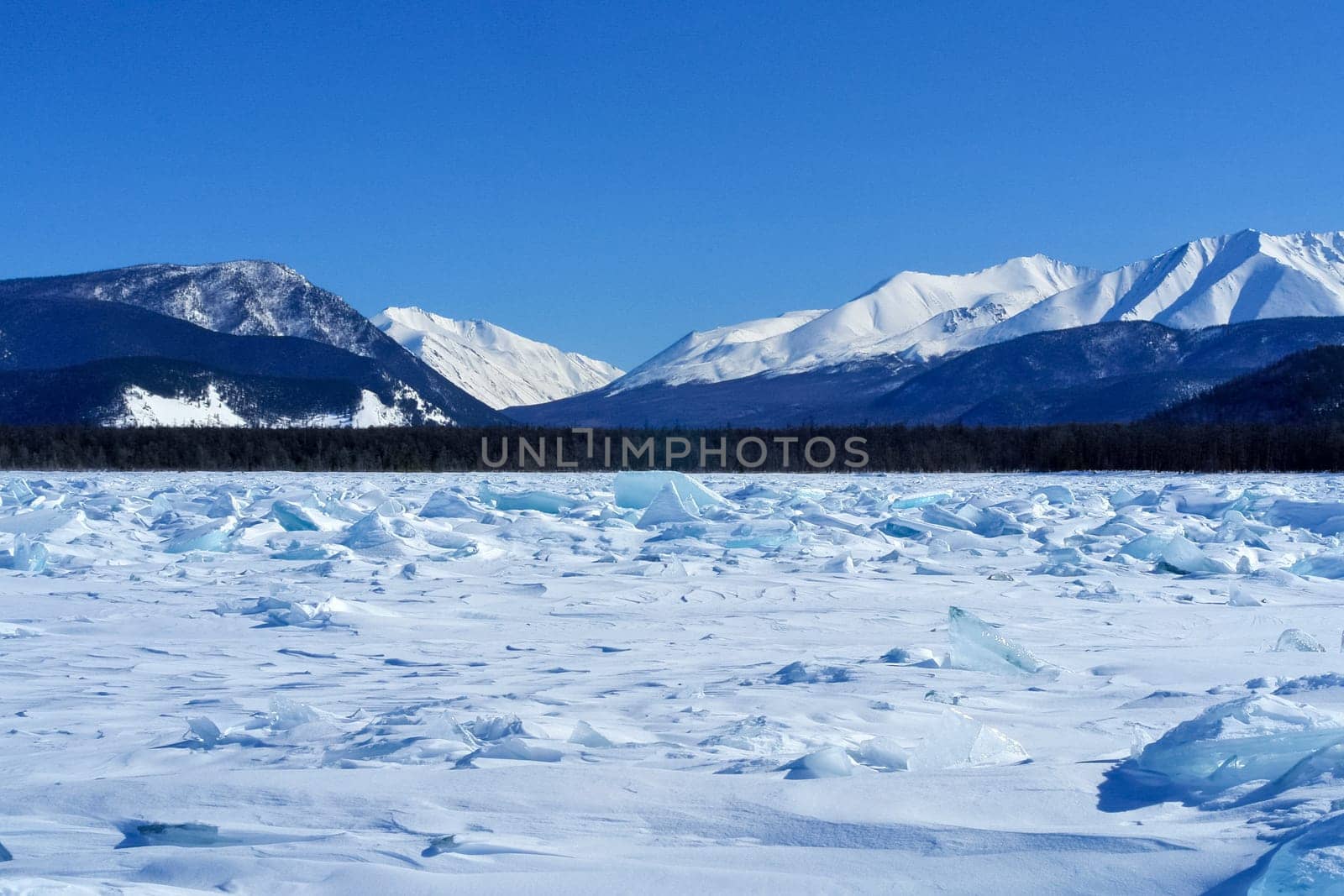 The shore of Lake Baikal in winter. Snow and ice on the baikal.
