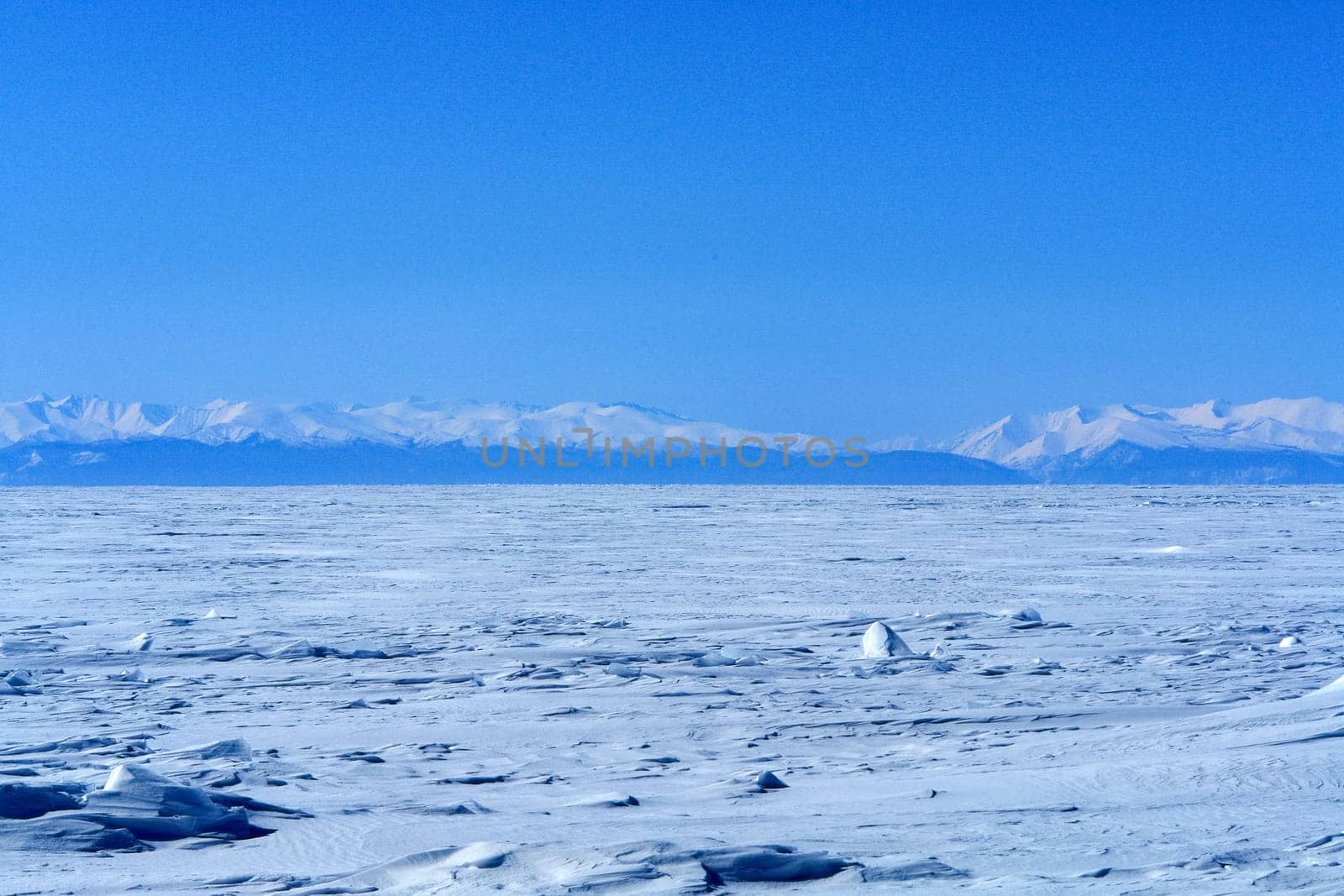 The shore of Lake Baikal in winter. Snow and ice on the baikal.