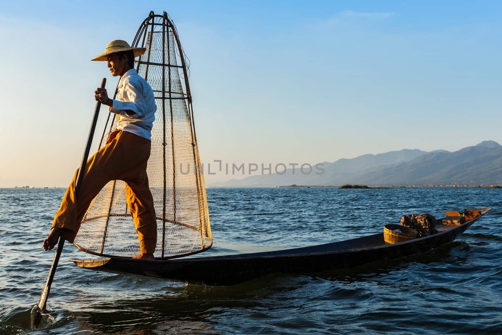 Myanmar travel attraction landmark - Traditional Burmese fisherman at Inle lake, Myanmar famous for their distinctive one legged rowing style