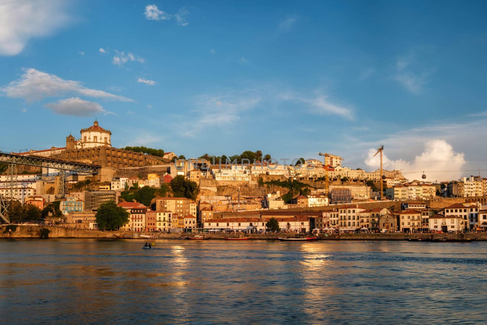 View of Vila Nova de Gaia city riverfront with Mosteiro da Serra do Pilar monastery and Dom Luis I bridge over Douro river on sunset. Porto, Vila Nova de Gaia, Portugal