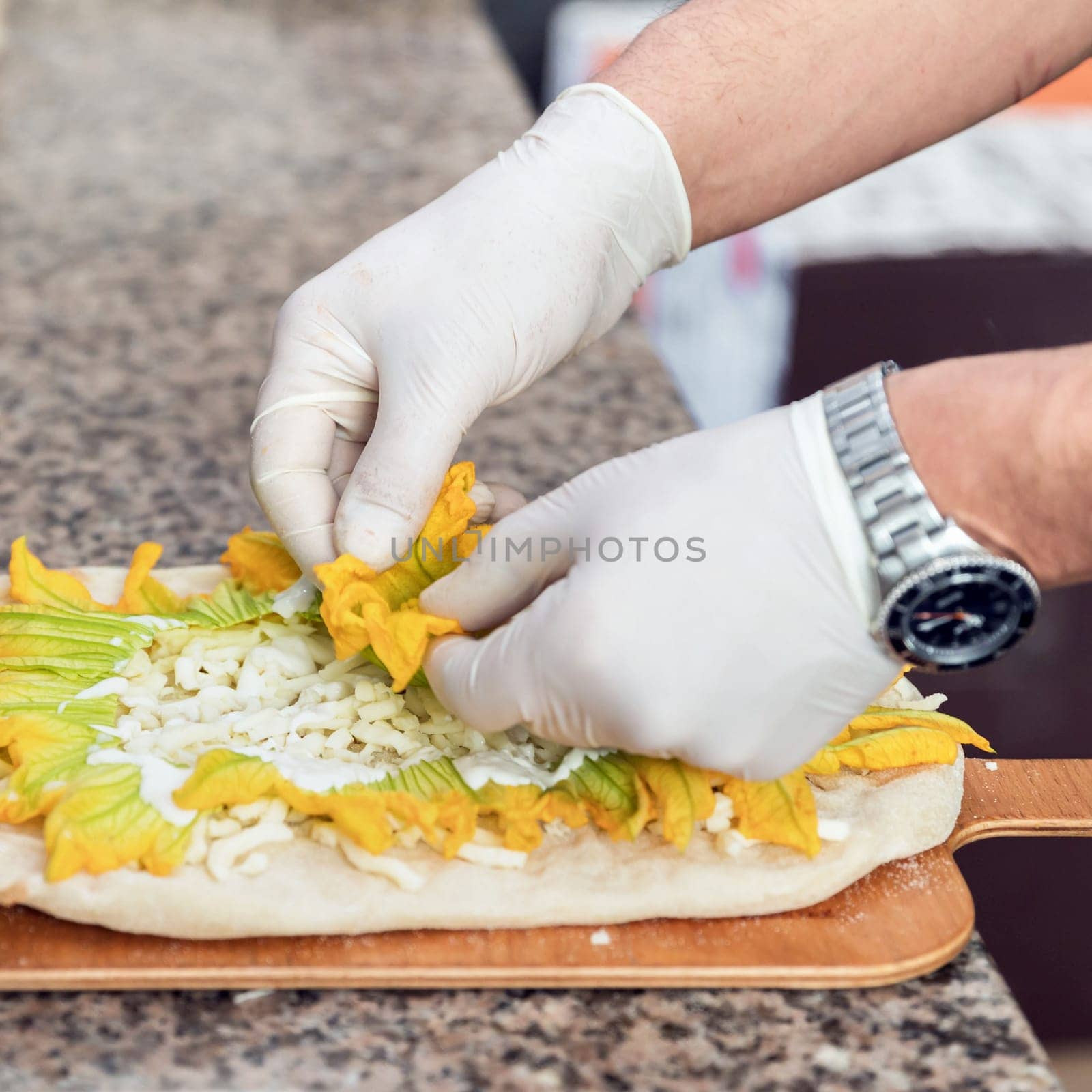 Hands of chef with white gloves making pizza. Pizza Art. The process of making pizza.