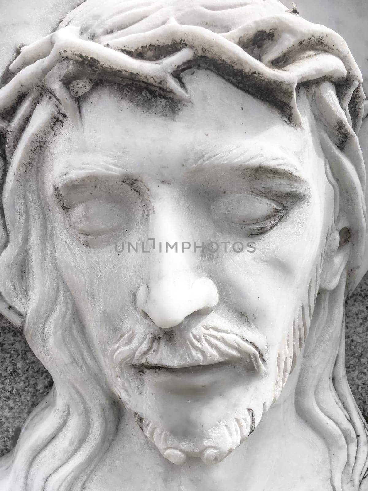 Death of Jesus. White marble statue of the face of the dying Jesus. Concepts and holidays. Easter.