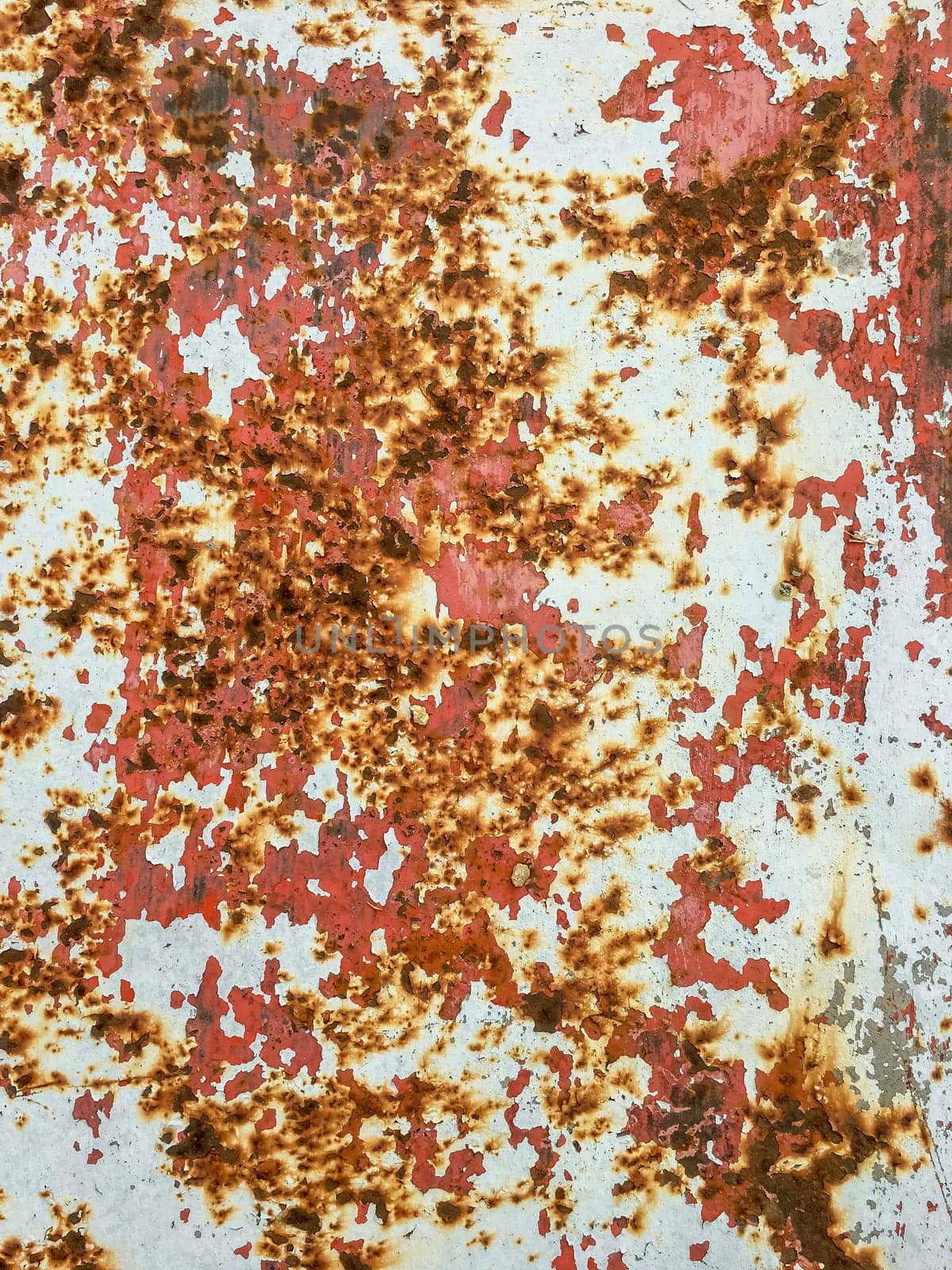 Corroded metal background. Rusted red painted metal wall. Rusty metal background with streaks of rust. Rust stains. The metal surface rusted spots.