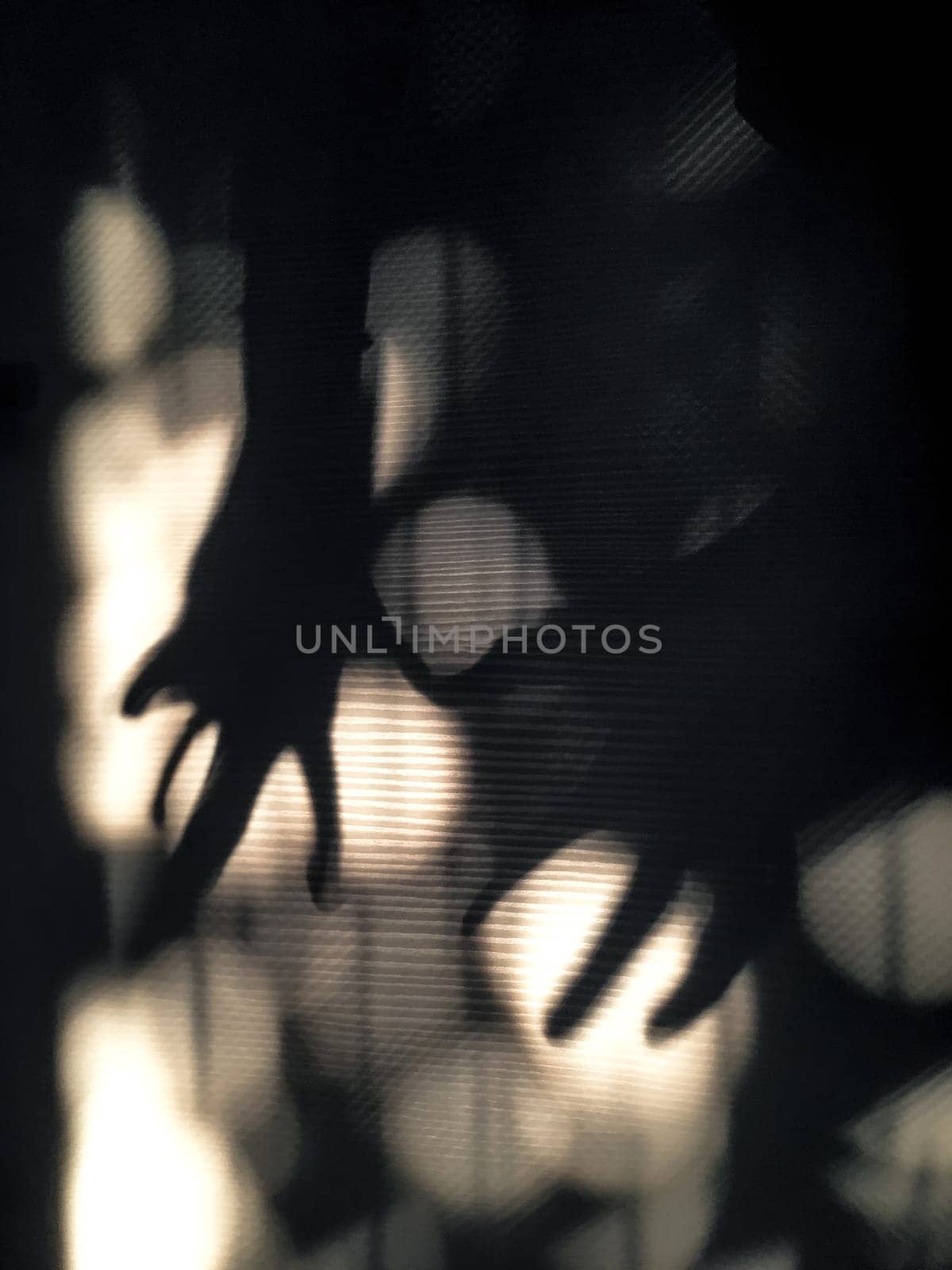 Abstract image of shadow hands grasping light