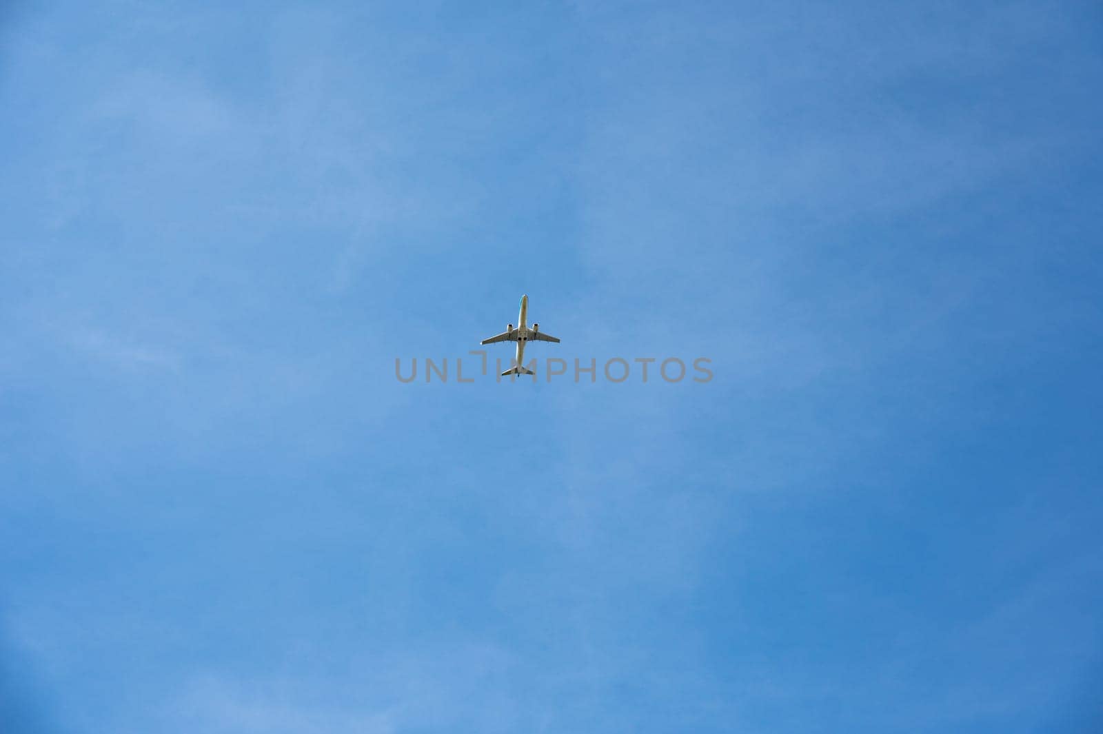 An airplane from below with a lot of sky