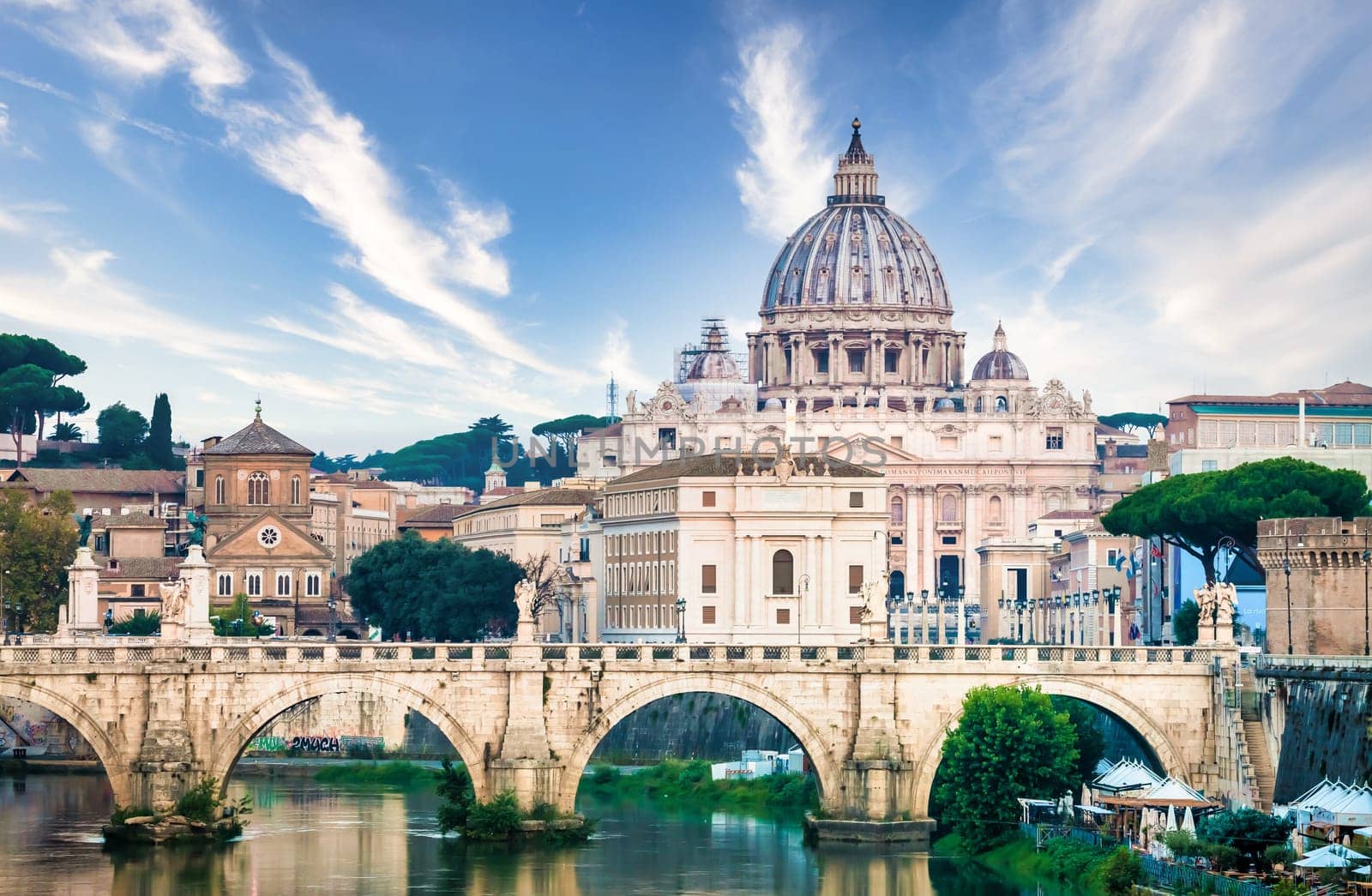 ROME, ITALY - JUNE 2023: Tiber river bridge with Vatican City and dome of Saint Peter Cathedral