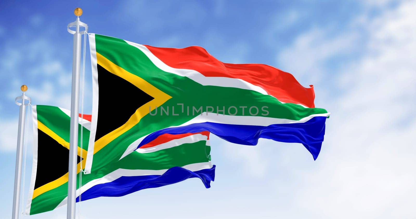 South Africa national flags waving. Red and blue flag divided by a green Y that encloses a black triangle with a yellow border. 3d illustration render. Selective focus.