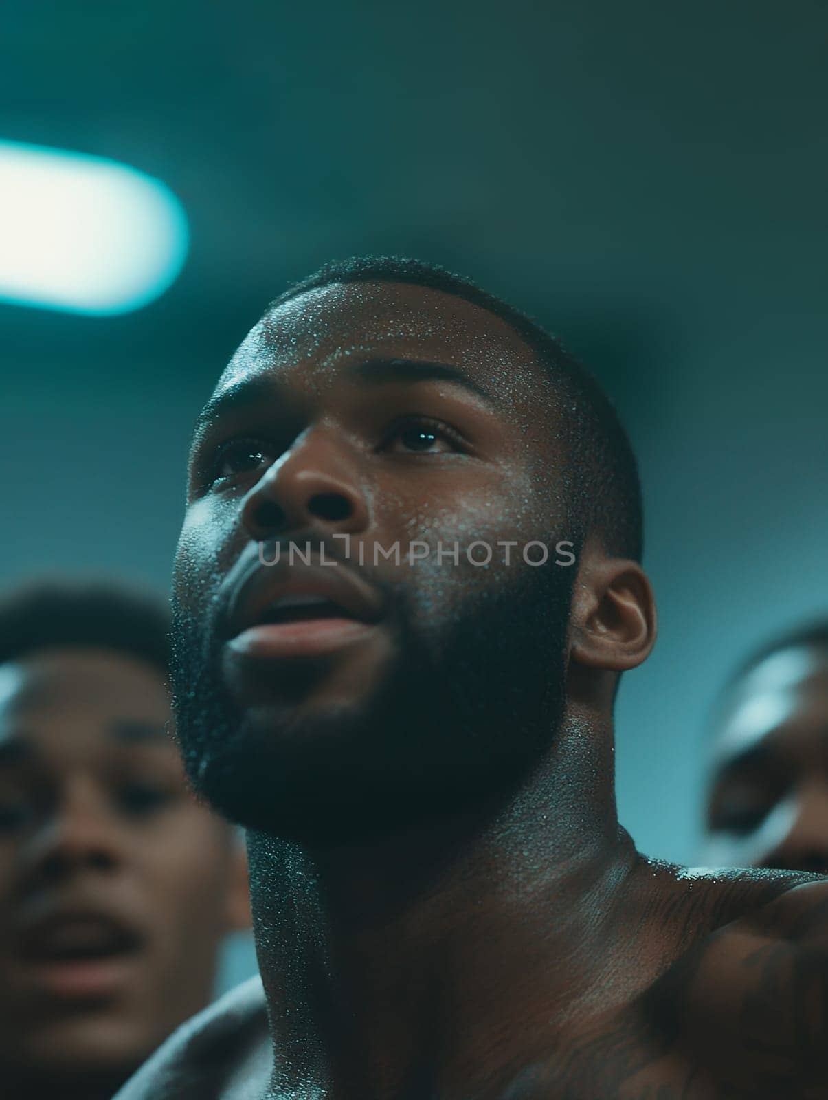 Close up of a determined athlete with sweat glistening, capturing the intensity and dedication of training.