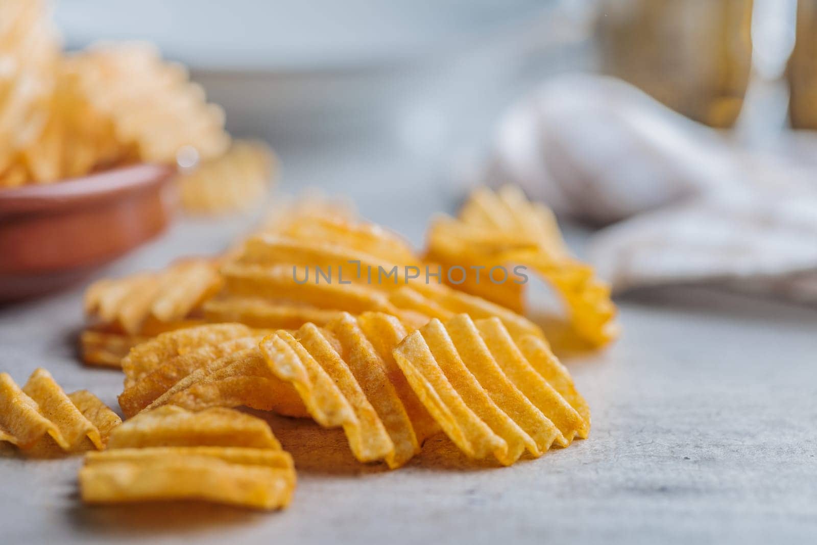 Crispy potato chips on a kitchen table.