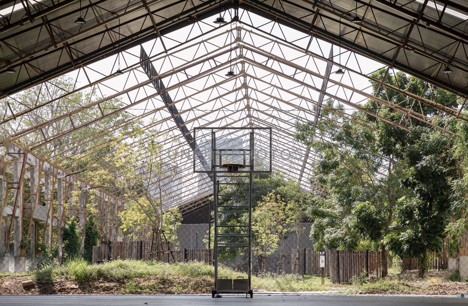 Bangkok, Thailand - Feb 19, 2025 - Basketball backboard with the hoop metal ring inside indoor basketball court at city park. use it as your Space for text, Design, Wallpaper and Poster, Selective focus.