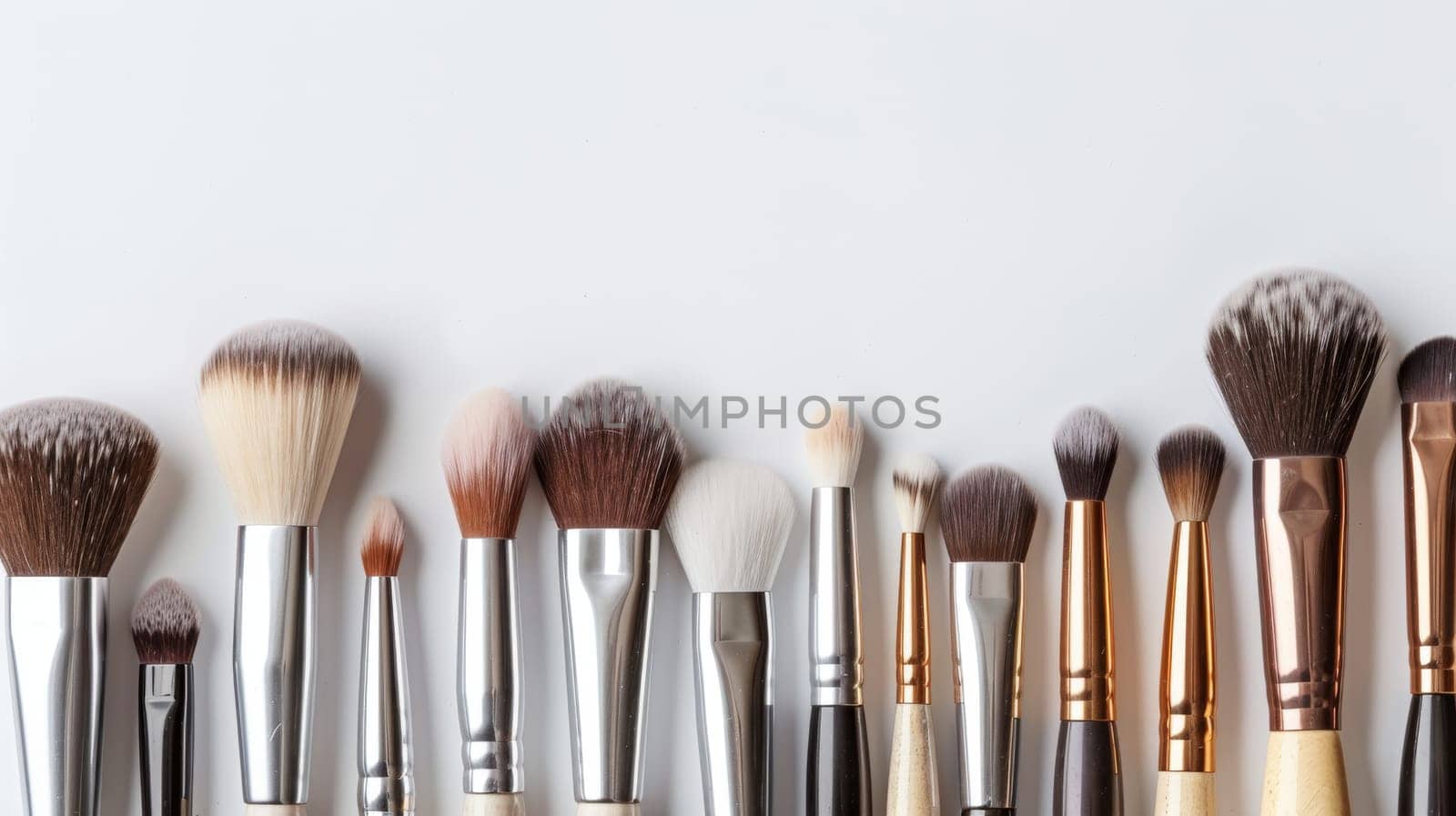 Clean copy space featuring a variety of makeup brushes and tools.