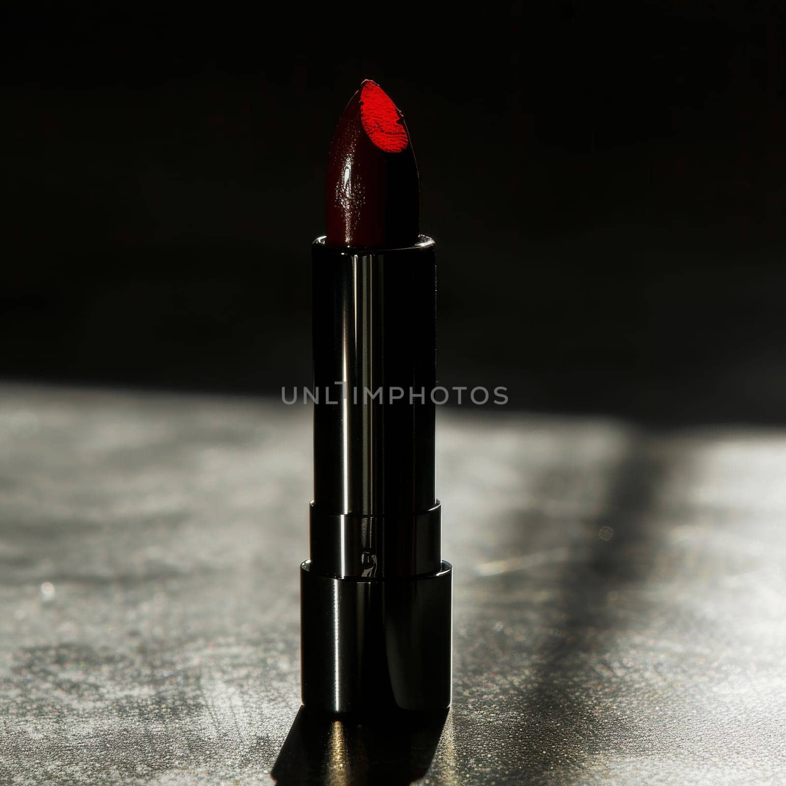 Striking silhouette of a lipstick bullet casting dramatic shadows.