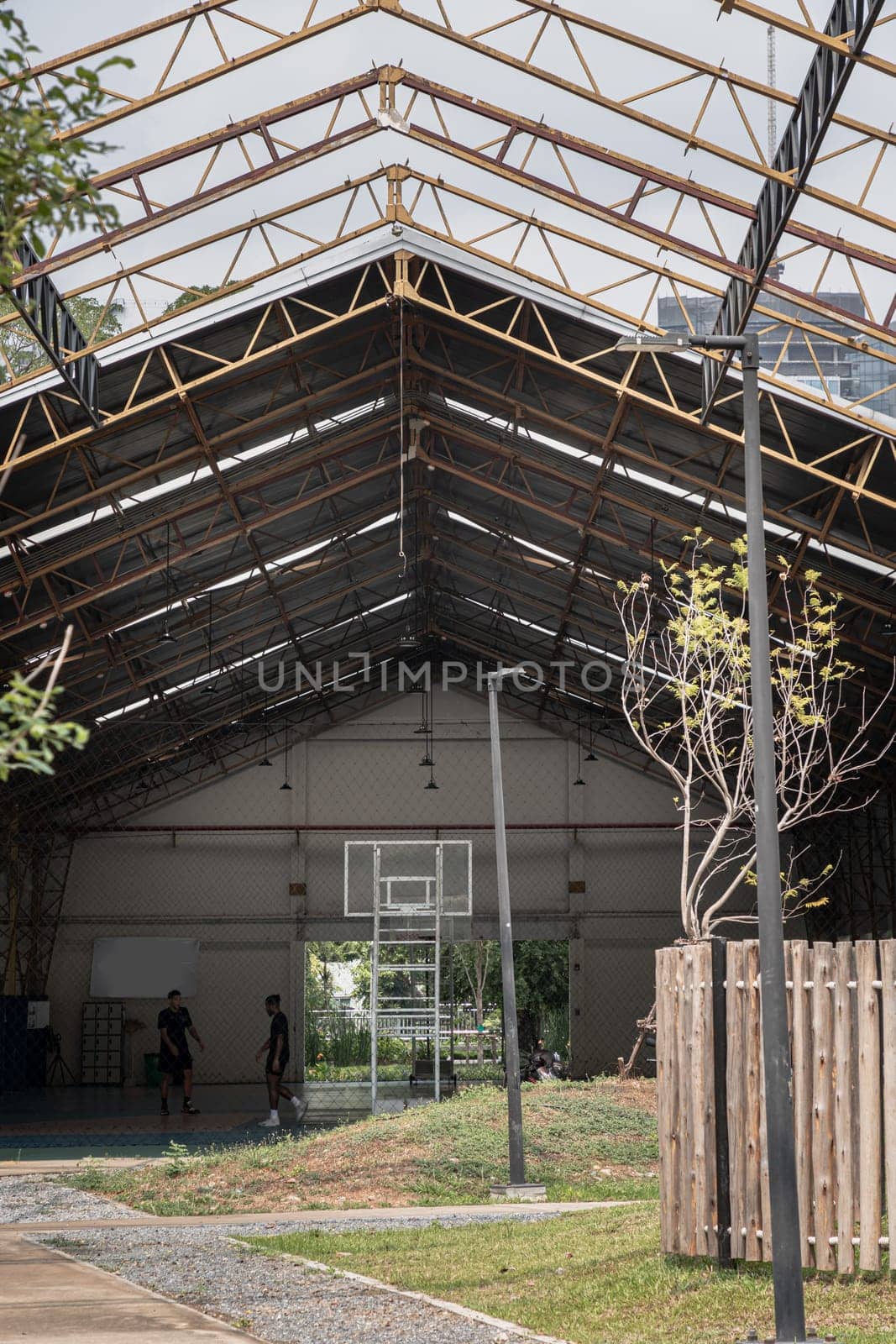 Bangkok, Thailand - Feb 19, 2025 - Basketball backboard with the hoop metal ring inside indoor basketball court at city park. use it as your Space for text, Design, Wallpaper and Poster, Selective focus.