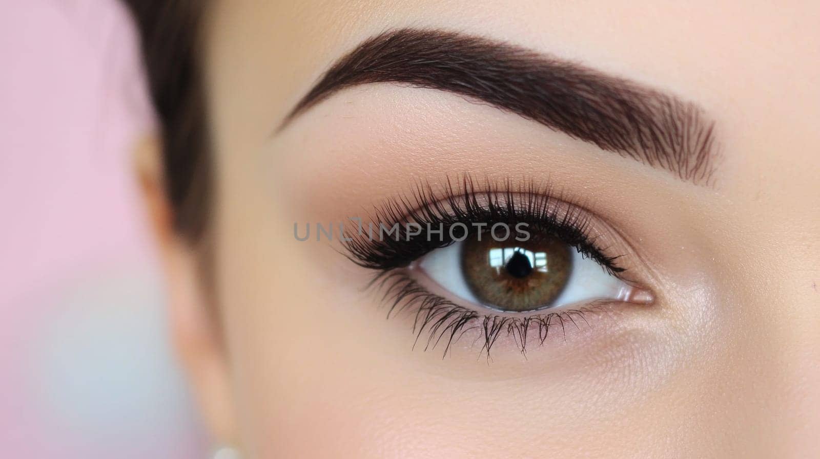 A close-up of the perfectly shaped eye and eyebrows, freshly tinted with a rich dark brown shade.