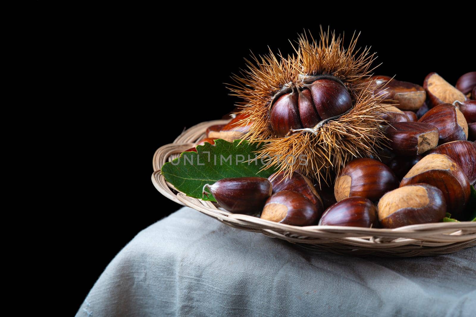 Chestnut with leaves on a wooden background