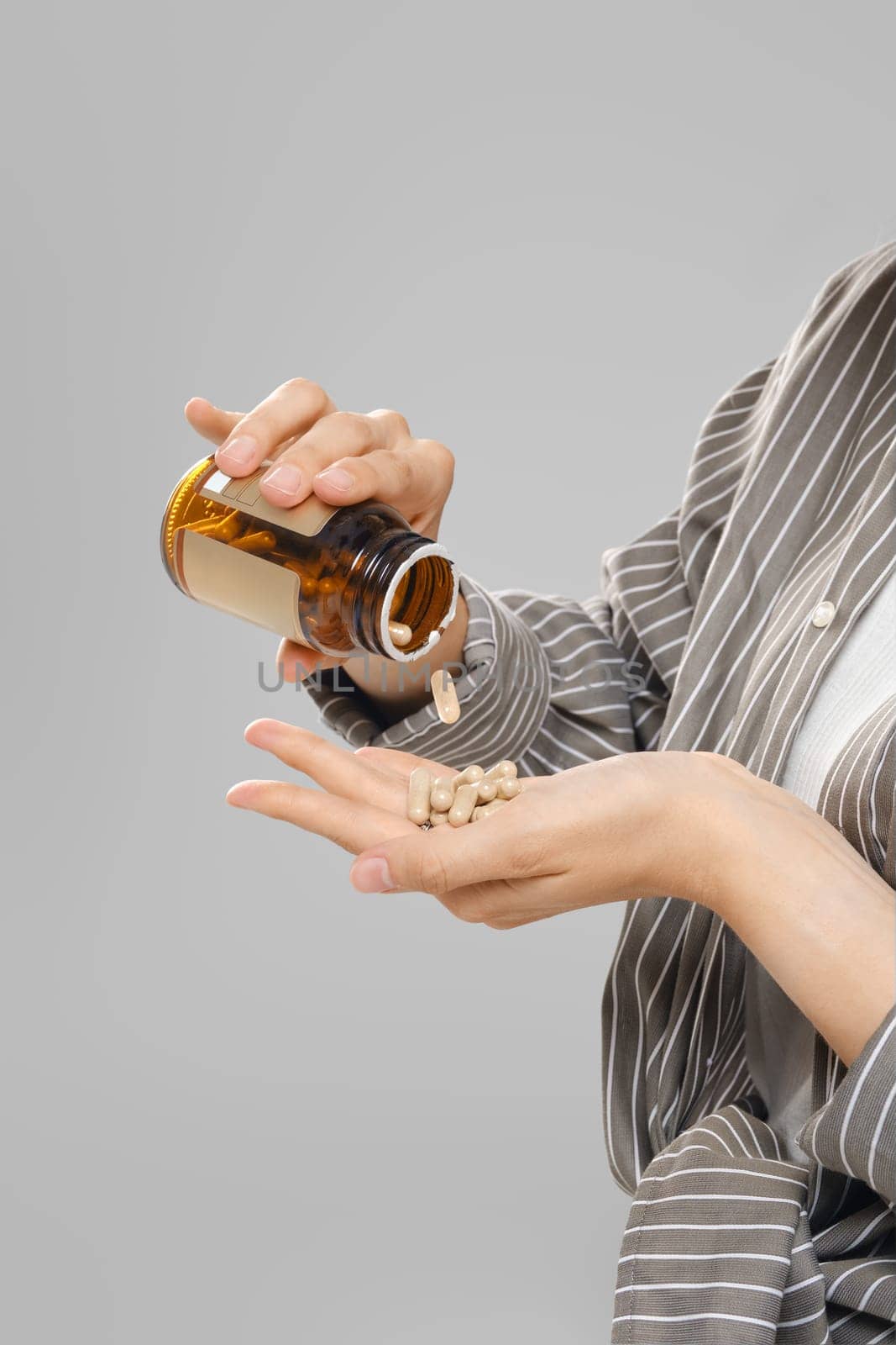 Close up view of pill falling out of a jar