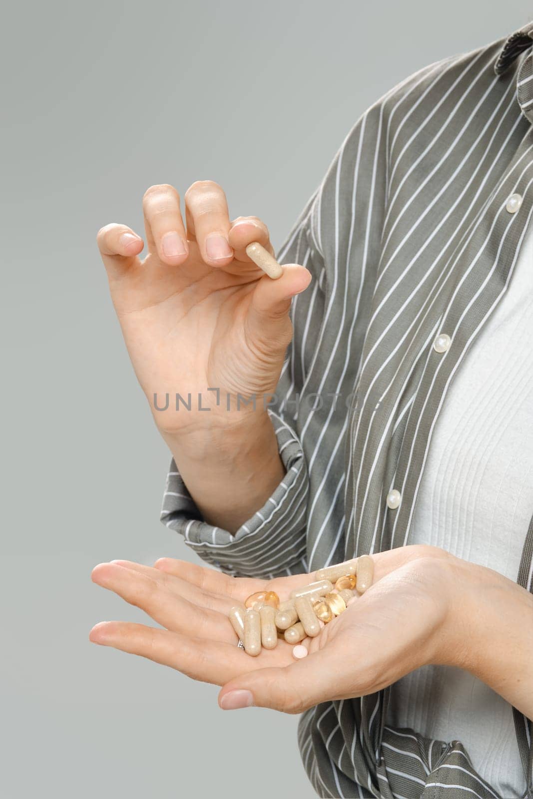 Cropped image of vitamins on a palm of unrecognizable woman