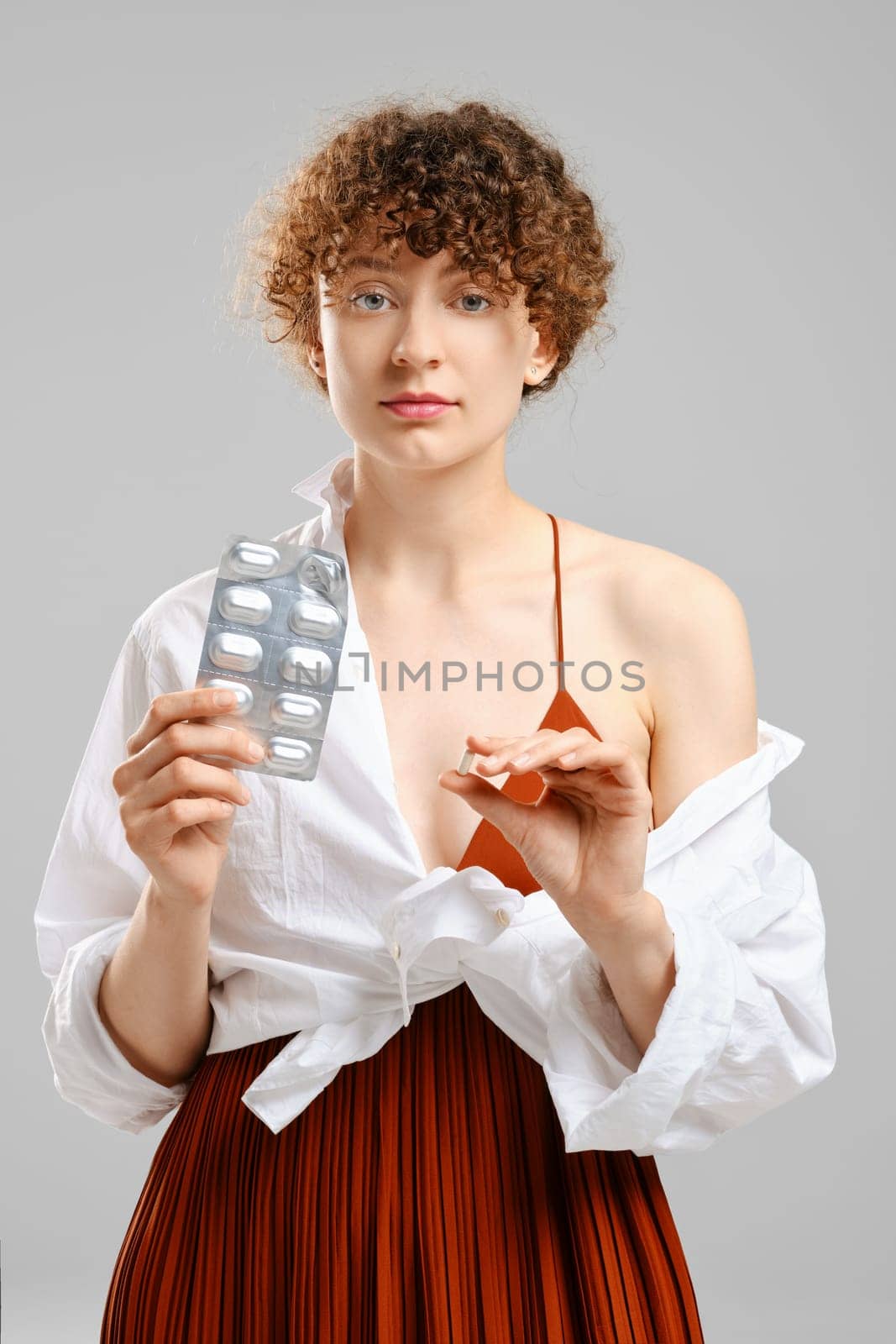 Woman holding a pack of pills in her hand. Concept of health care, protection or timely identification of the problem