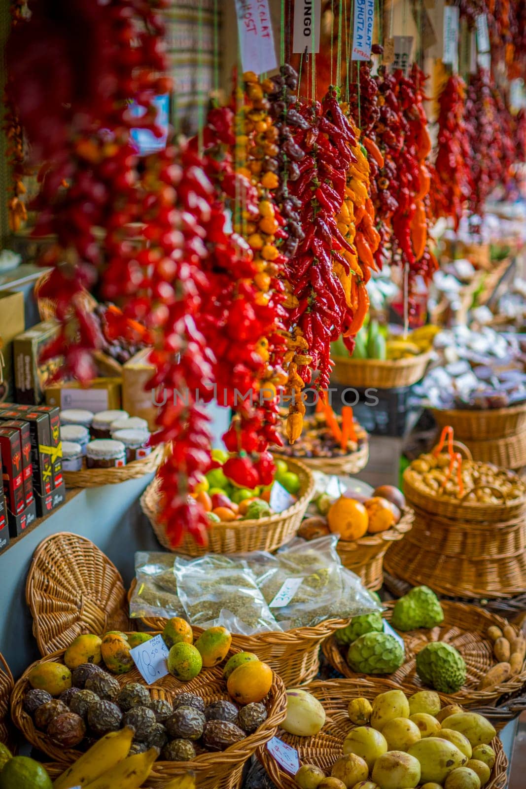 Funchal, Madeira, Portugal, November 7th 2024: View on peppers and fruits in a market stall of Mercado dos Lavradores, Farmers market, in Funchal, Madeira