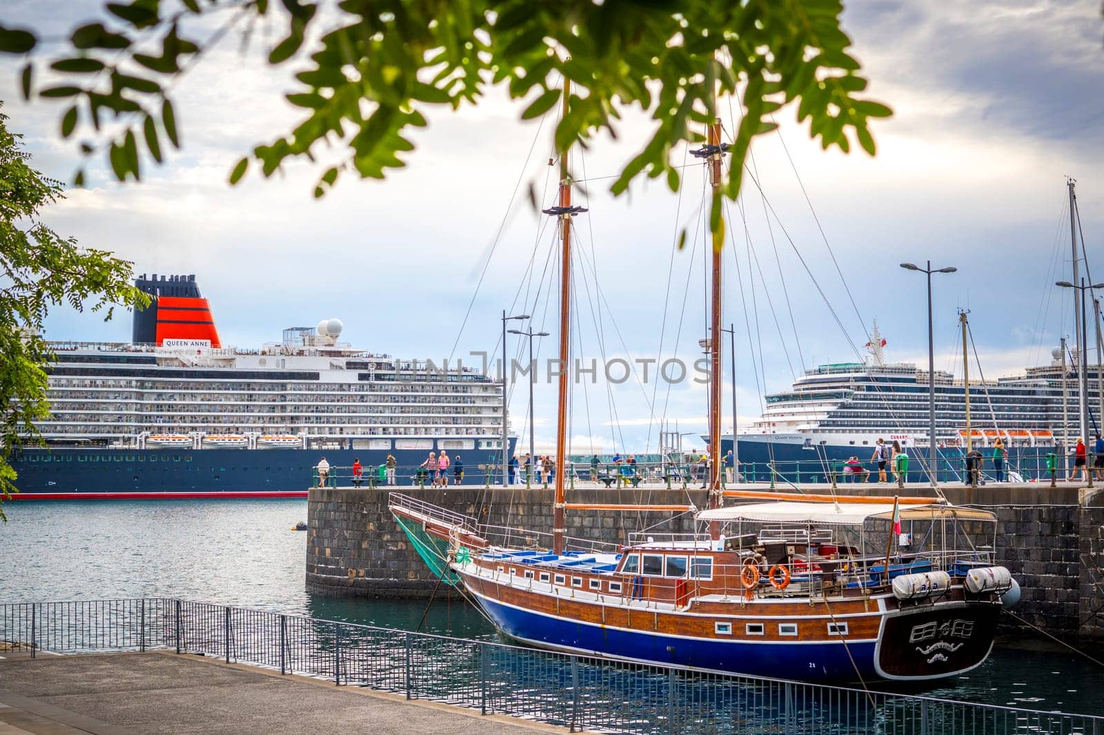 Funchal, Madeira, Portugal, November 7th 2024: Illustrative Editorial: View on cruiseship Queen Anne operated by Cunard Line in the harbor of Funchal, Madeira, with Bonita da Madeira wooden gulet in front