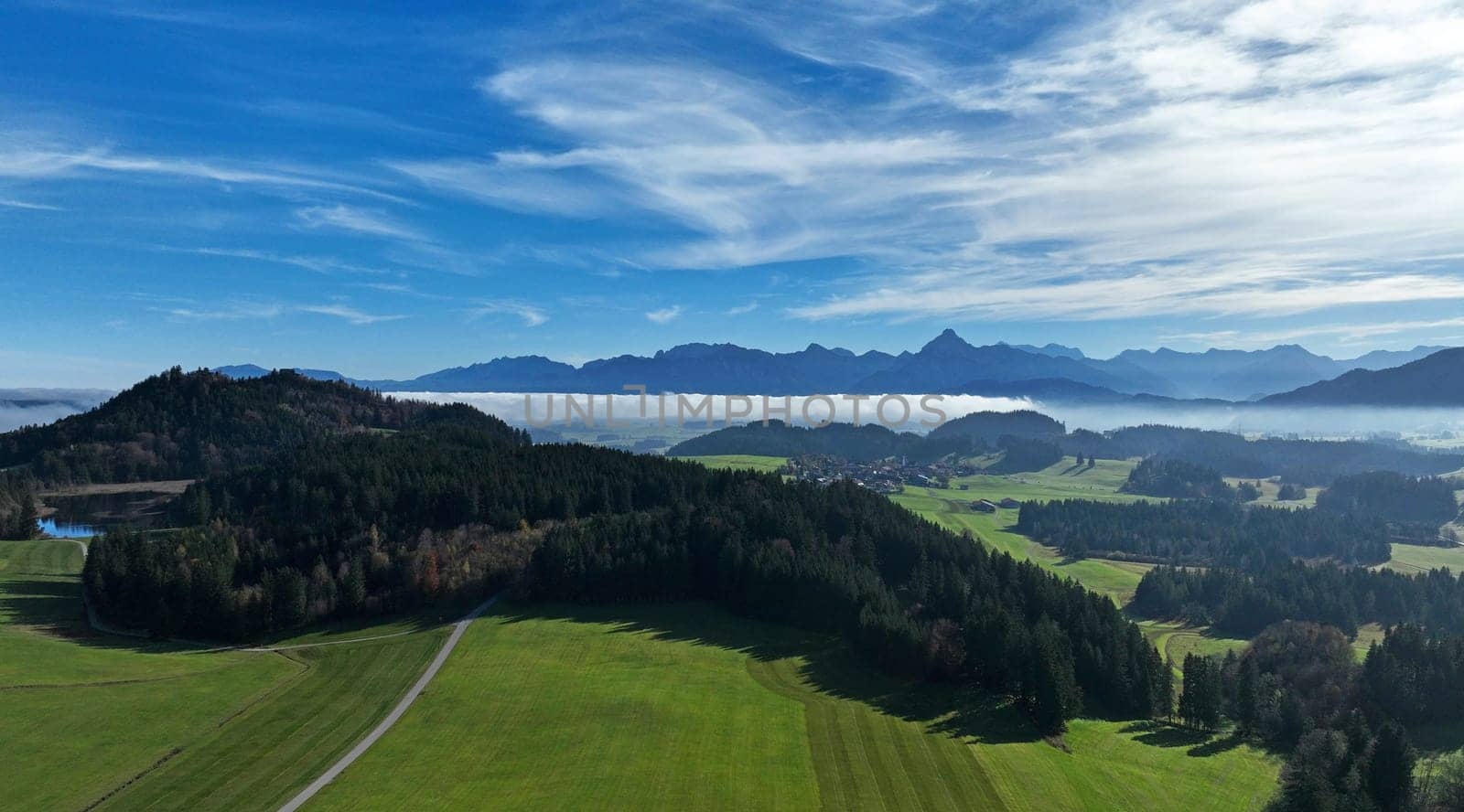 Drone shot of the Allgu Alps with fog in front of the mountains