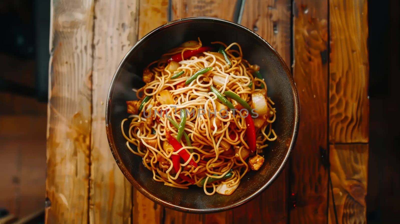 Aerial shot of a spinning bowl of noodle stir-fry