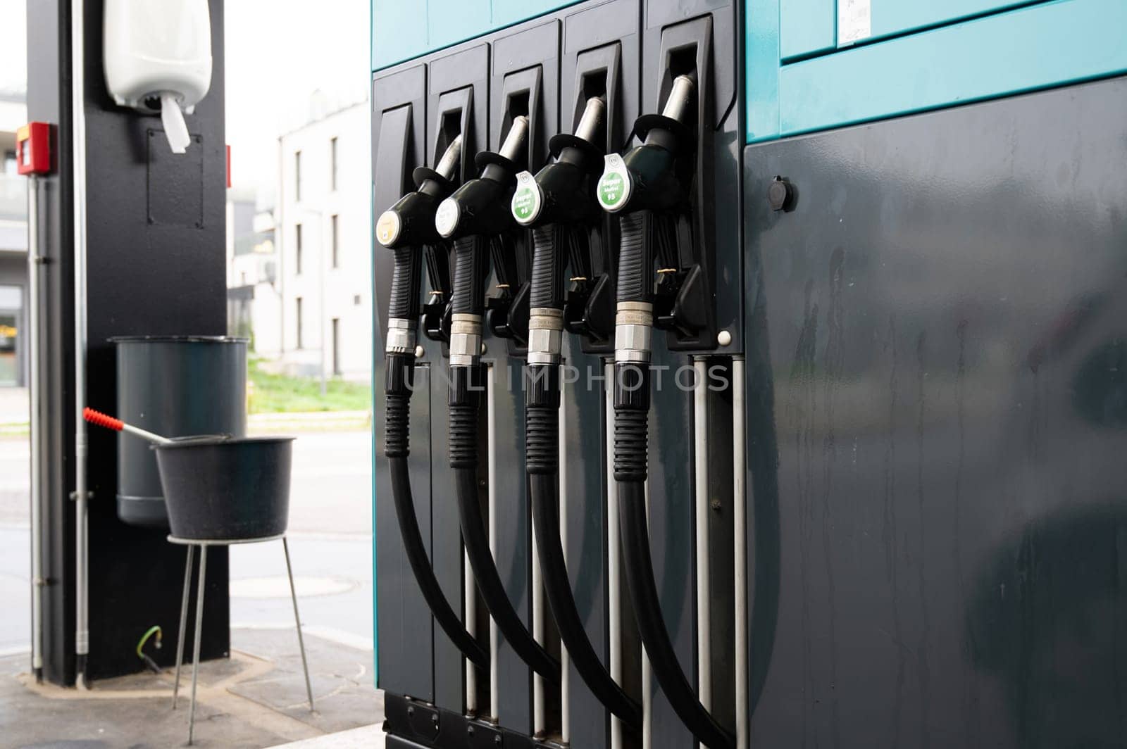 Gasoline dispenser to add gas to car, gas station with petrol and diesel fuel pump nozzles, increase of costs