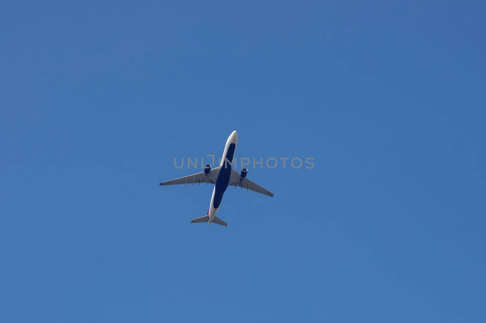 An airplane from below with a lot of sky,An airplane from below with a lot of sky