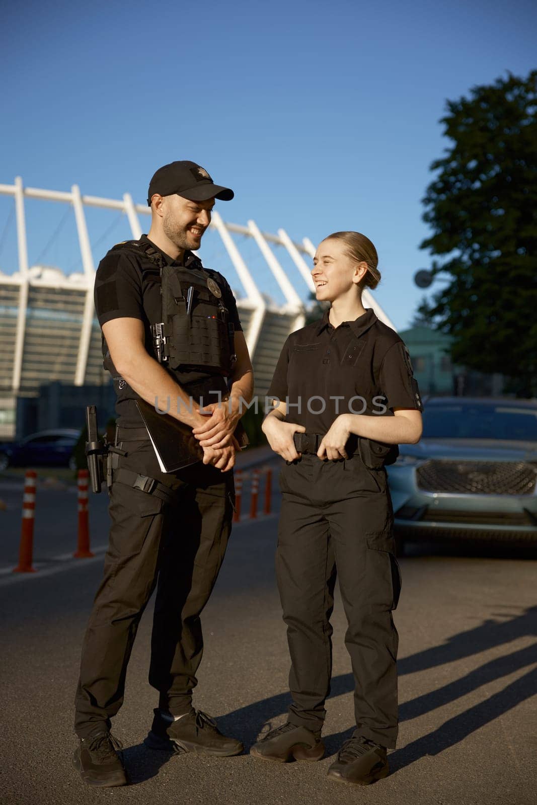 Friendly smiling patrol police officers on the street during the watch