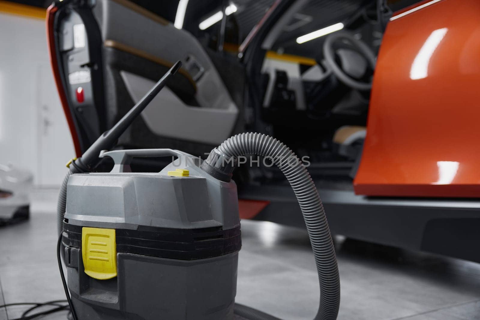 Closeup view on professional vacuum cleaner for car salon washing, cleaning disinfection. Auto wash service concept