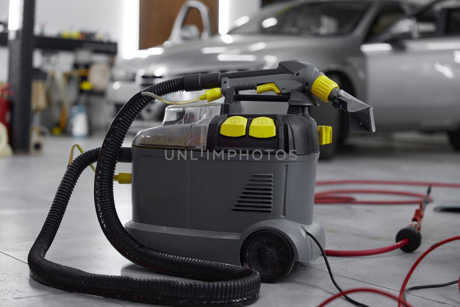 Closeup view on professional vacuum cleaner for car salon washing, cleaning disinfection. Auto wash service concept