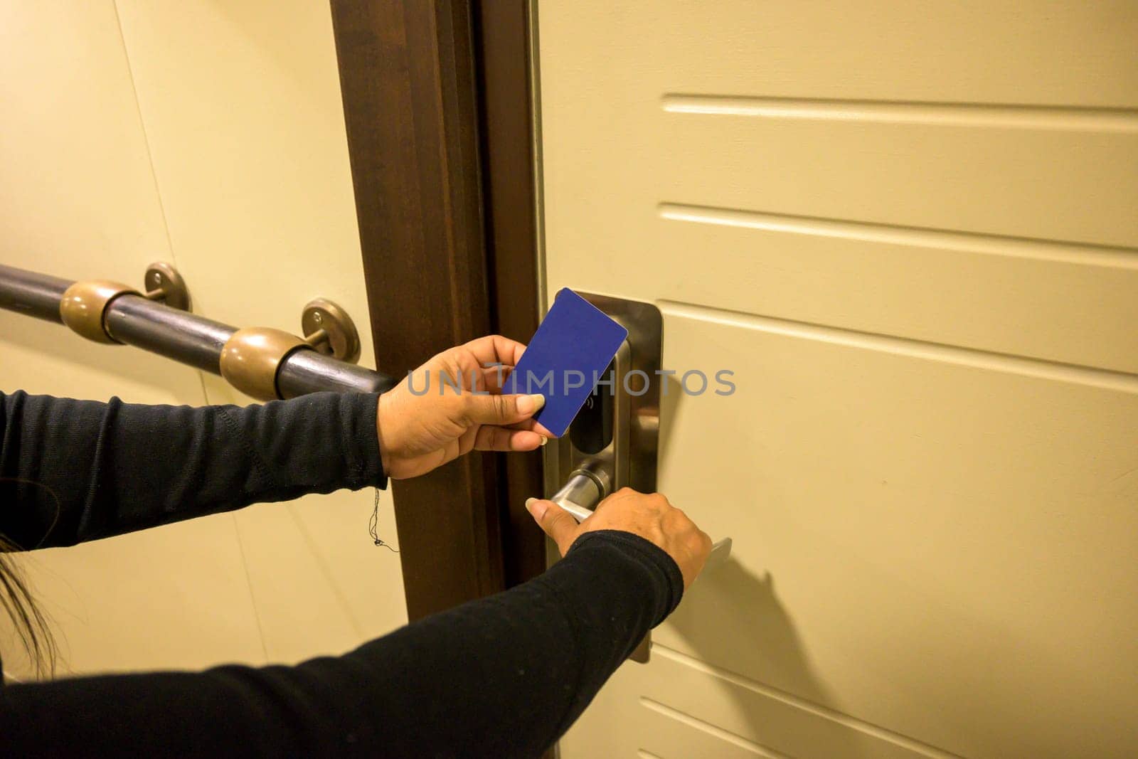 Latin Woman opens a door with a keycard in a hallway, key electronic lock, hotel room, holidays in mallorca, spain.