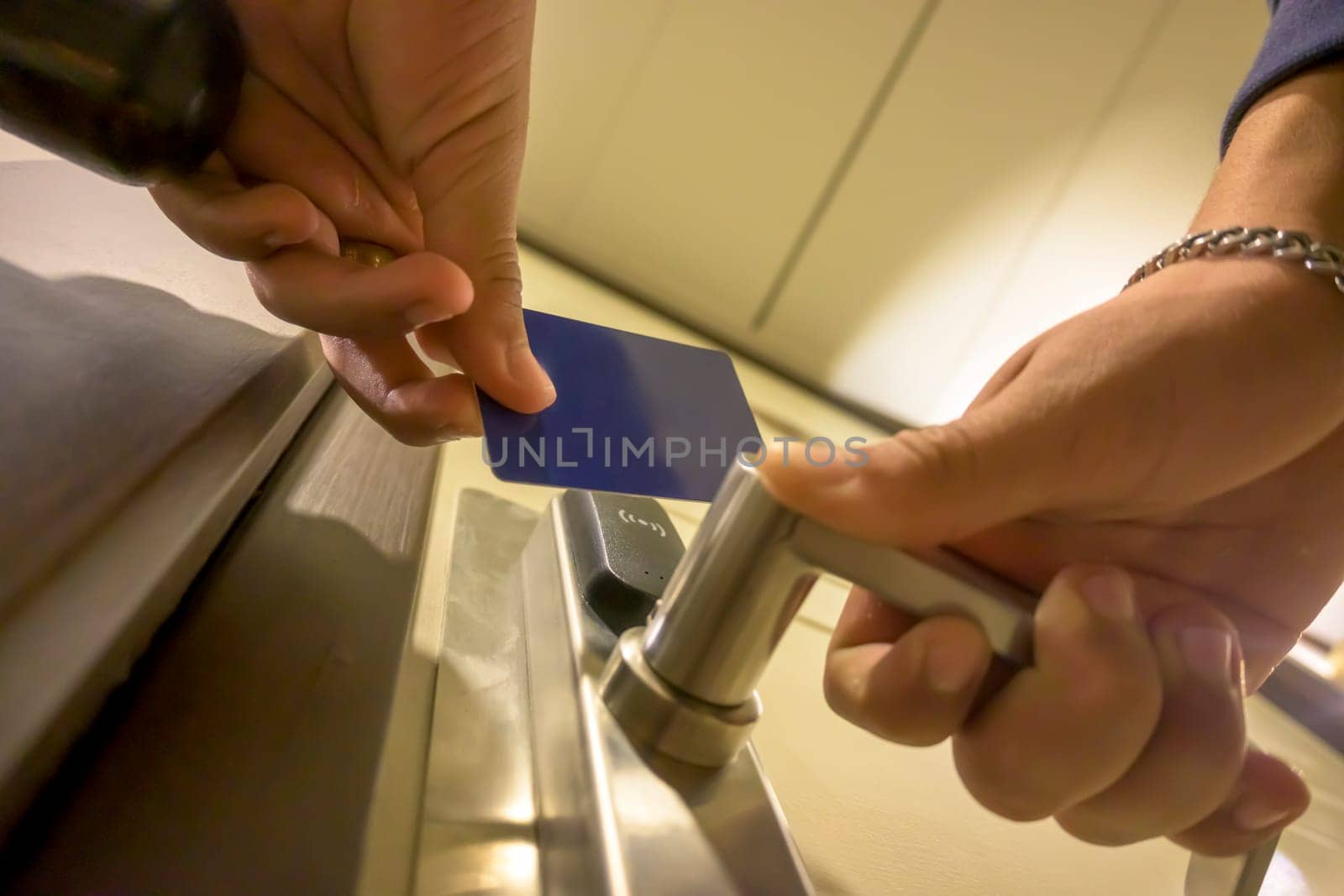 Close-up of a hand using a blue card key in a hotel door lock, key electronic lock, hotel room, holidays in mallorca, spain